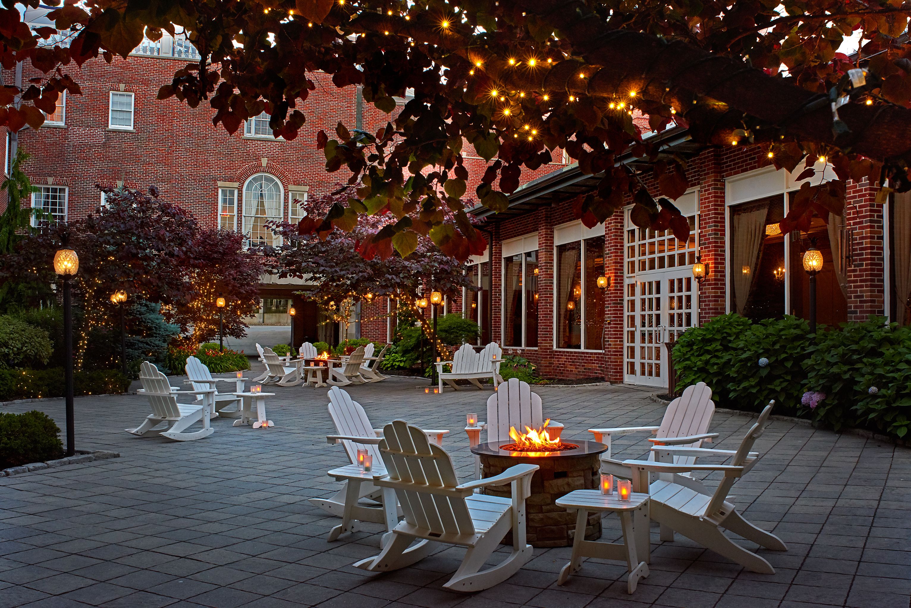 a patio with chairs and a fire pit