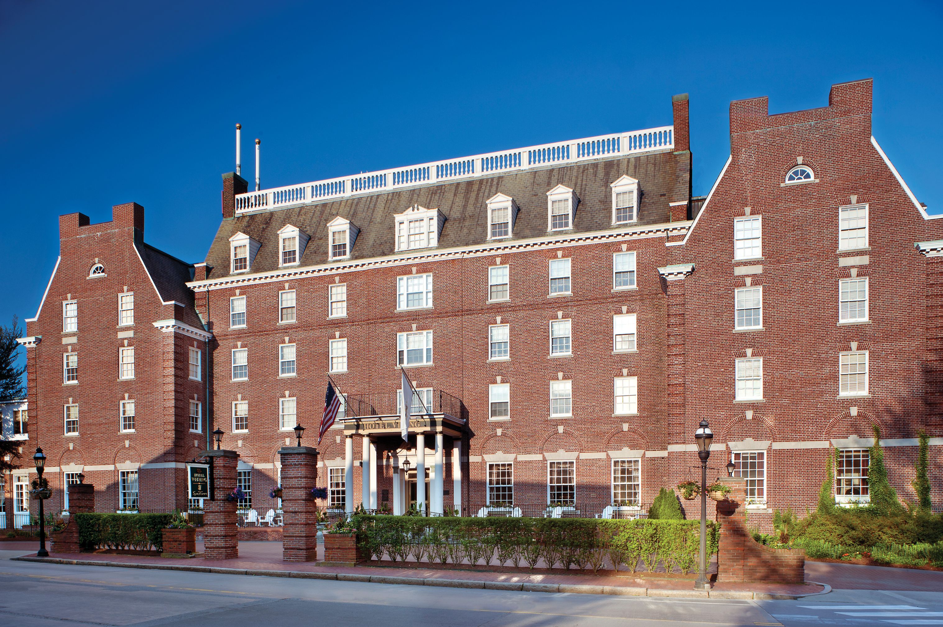 a large brick building with a flag on the front