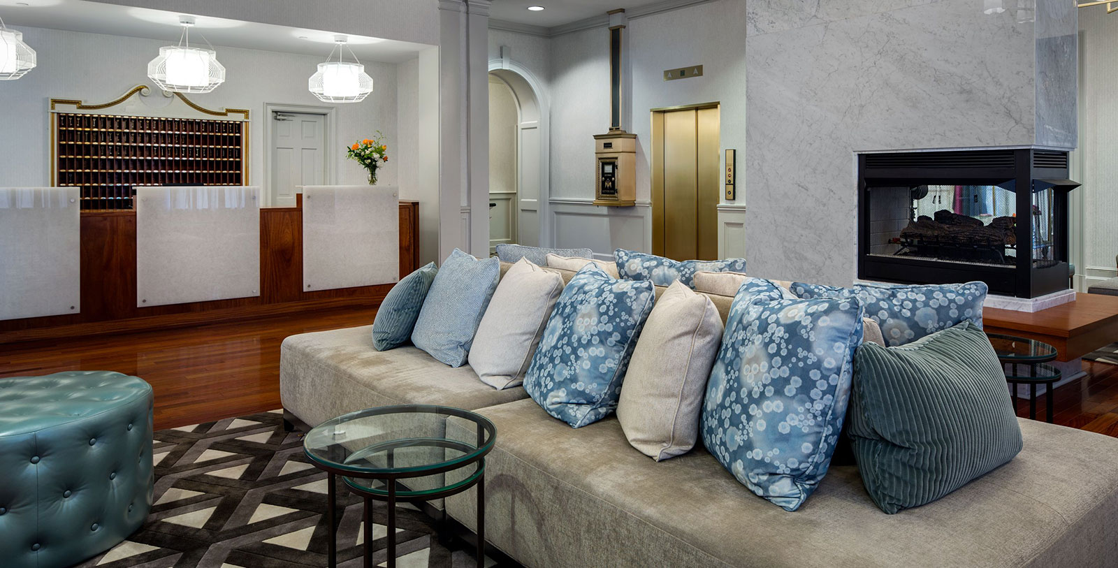 a couch with pillows in a lobby