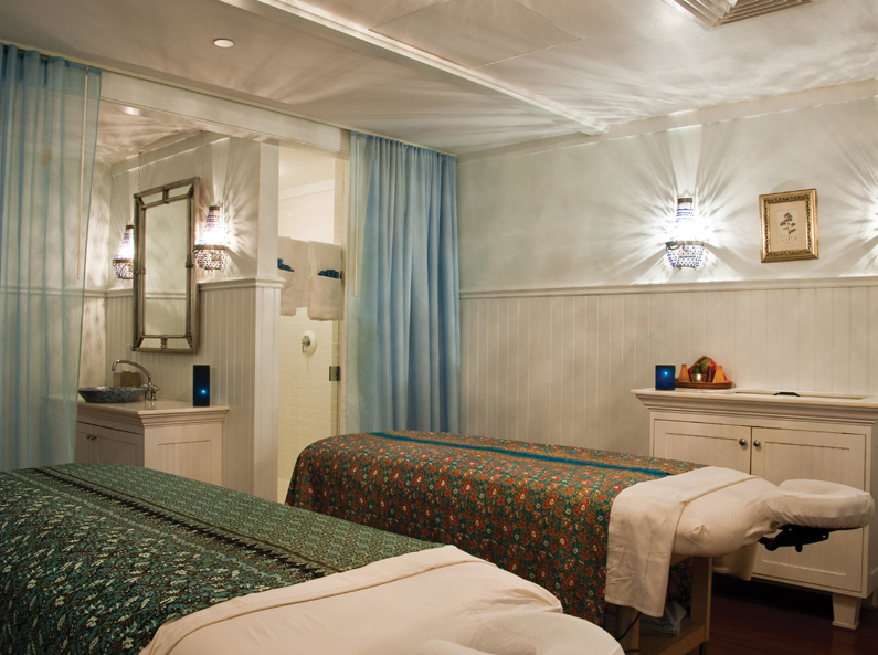 a room with two beds and a mirror