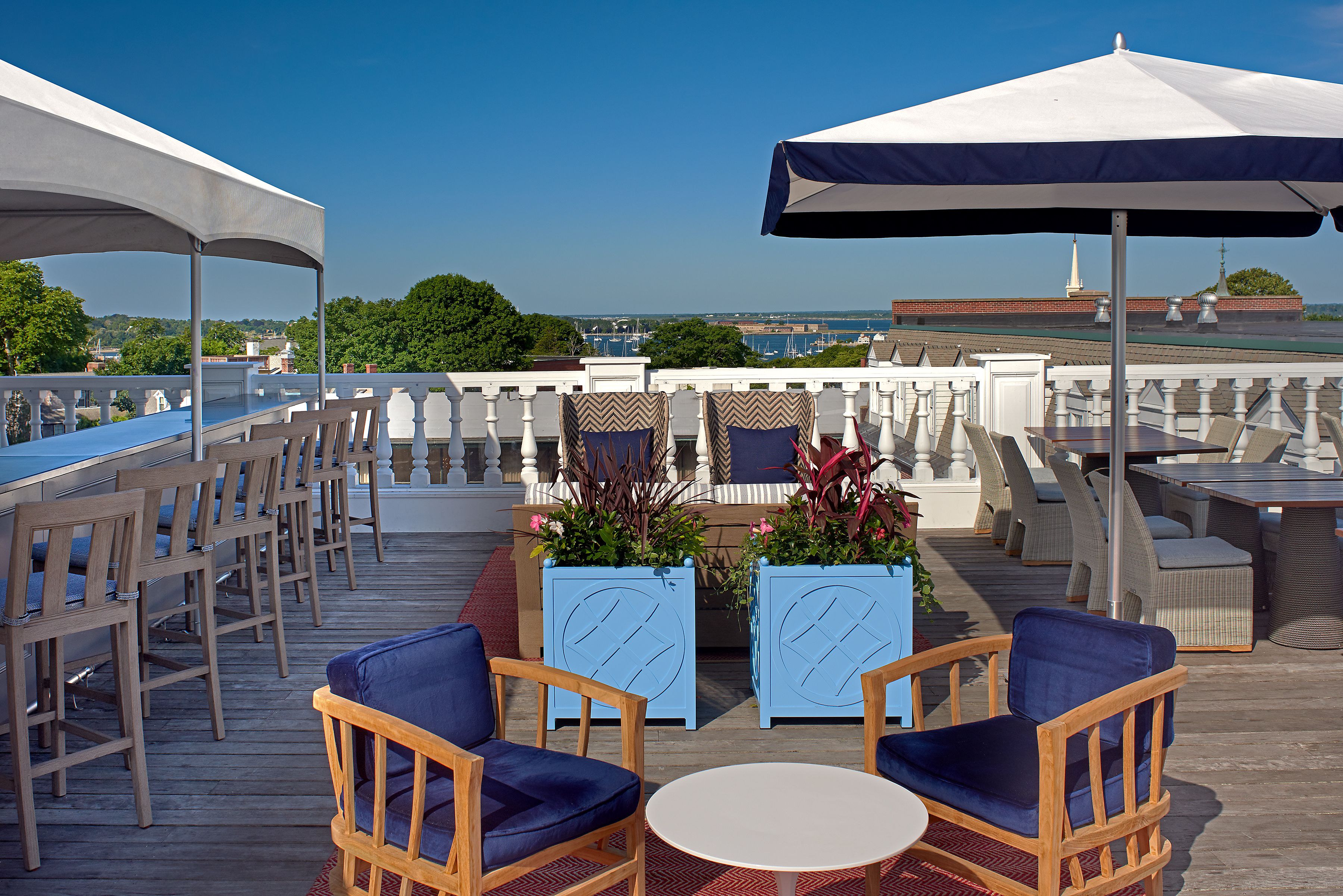 a patio with chairs and tables and chairs on a deck
