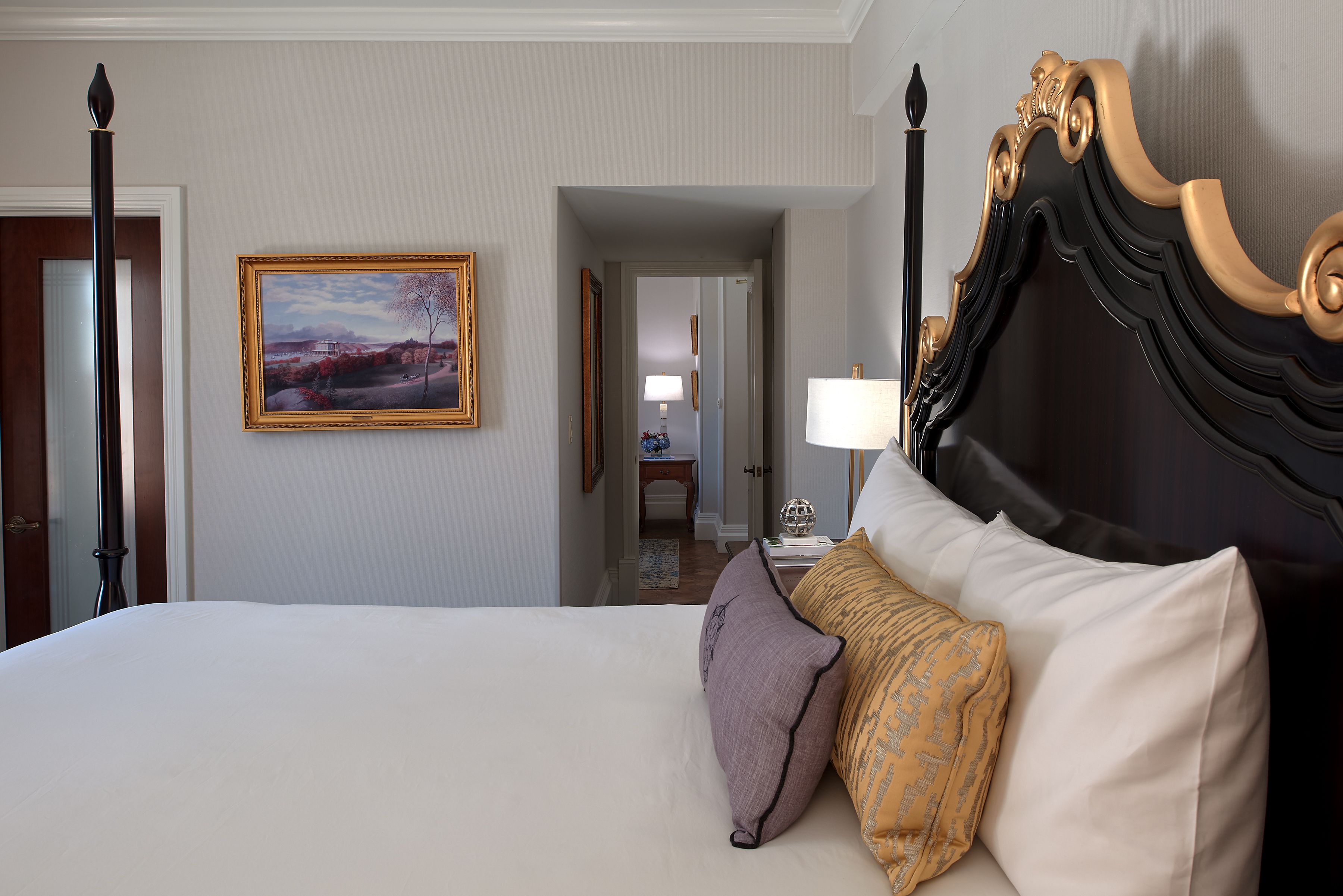 a bed with pillows and a lamp on it