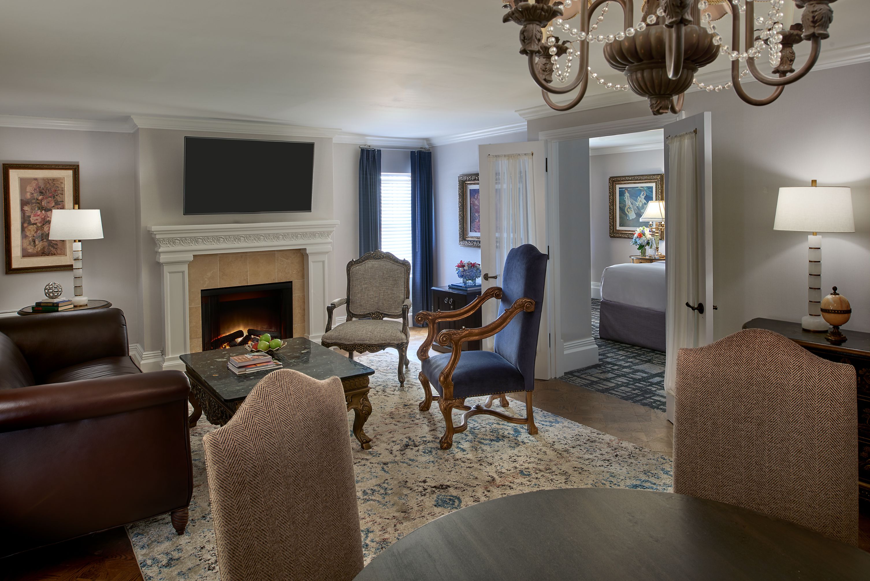 a living room with a fireplace and chairs