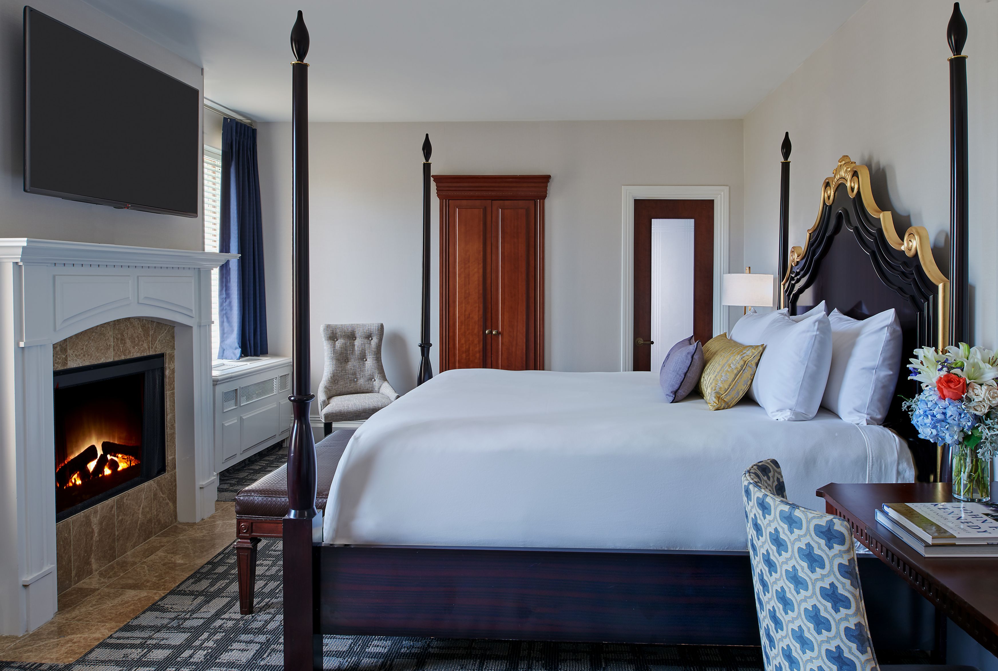 a room with a bed and fireplace