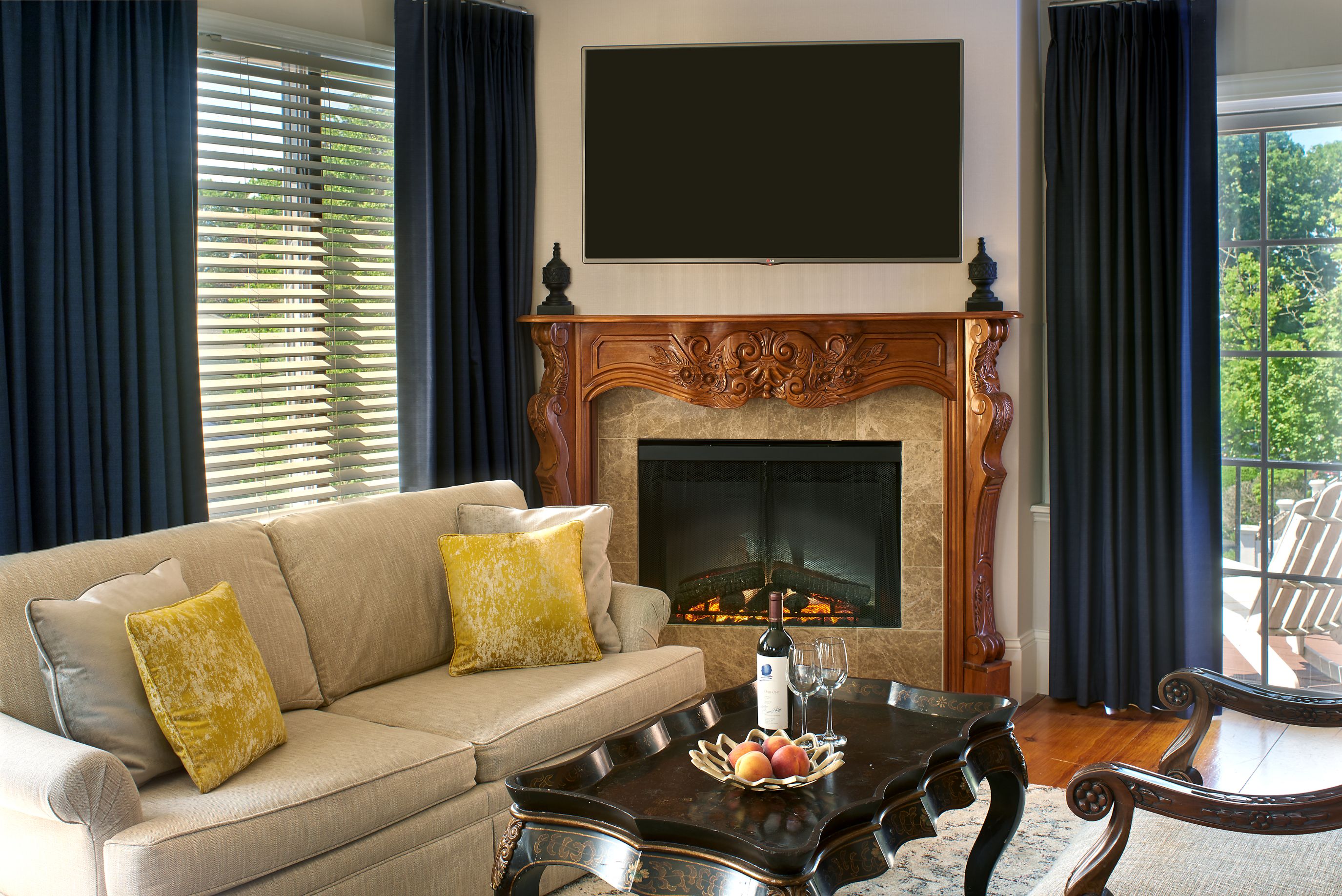 a living room with a fireplace and a tv