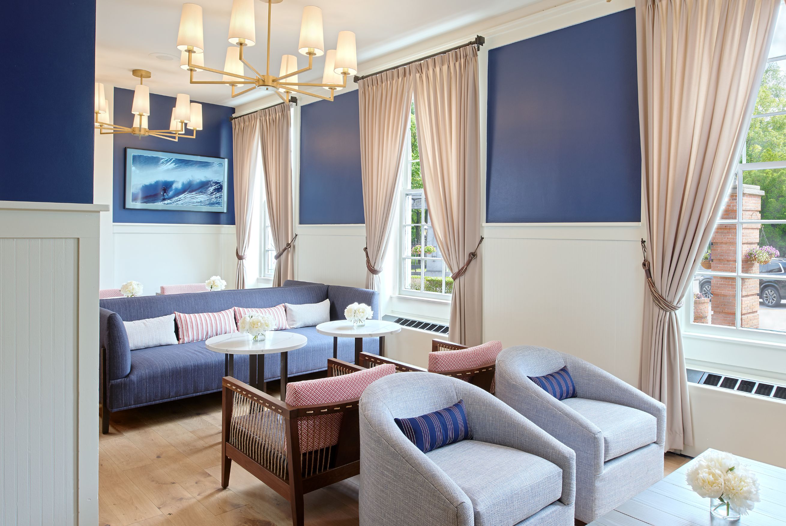 a room with a couch and chairs