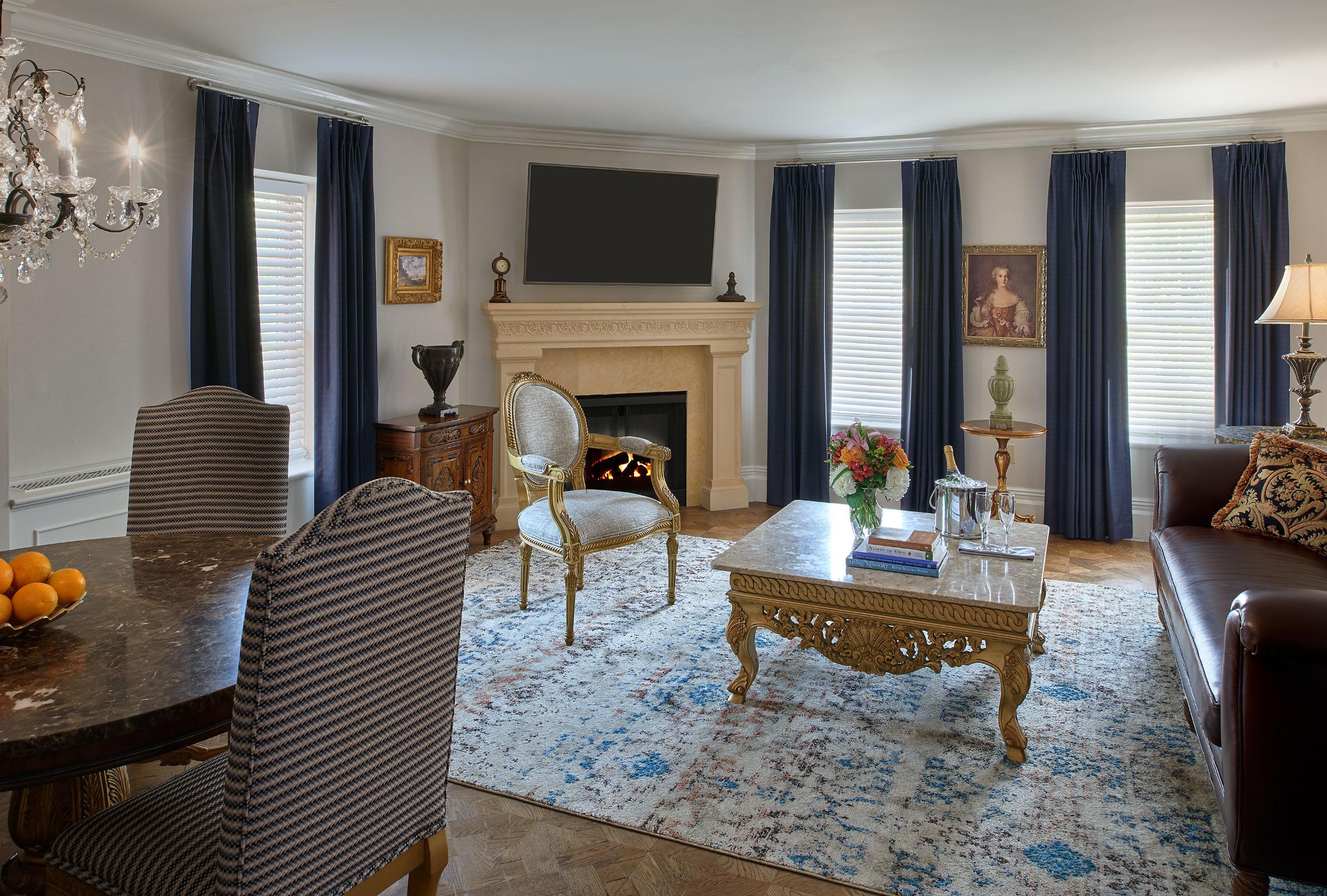 a living room with a fireplace and chairs