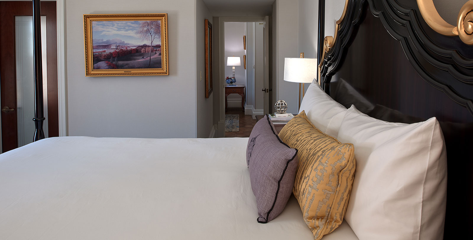 a bed with pillows and a lamp
