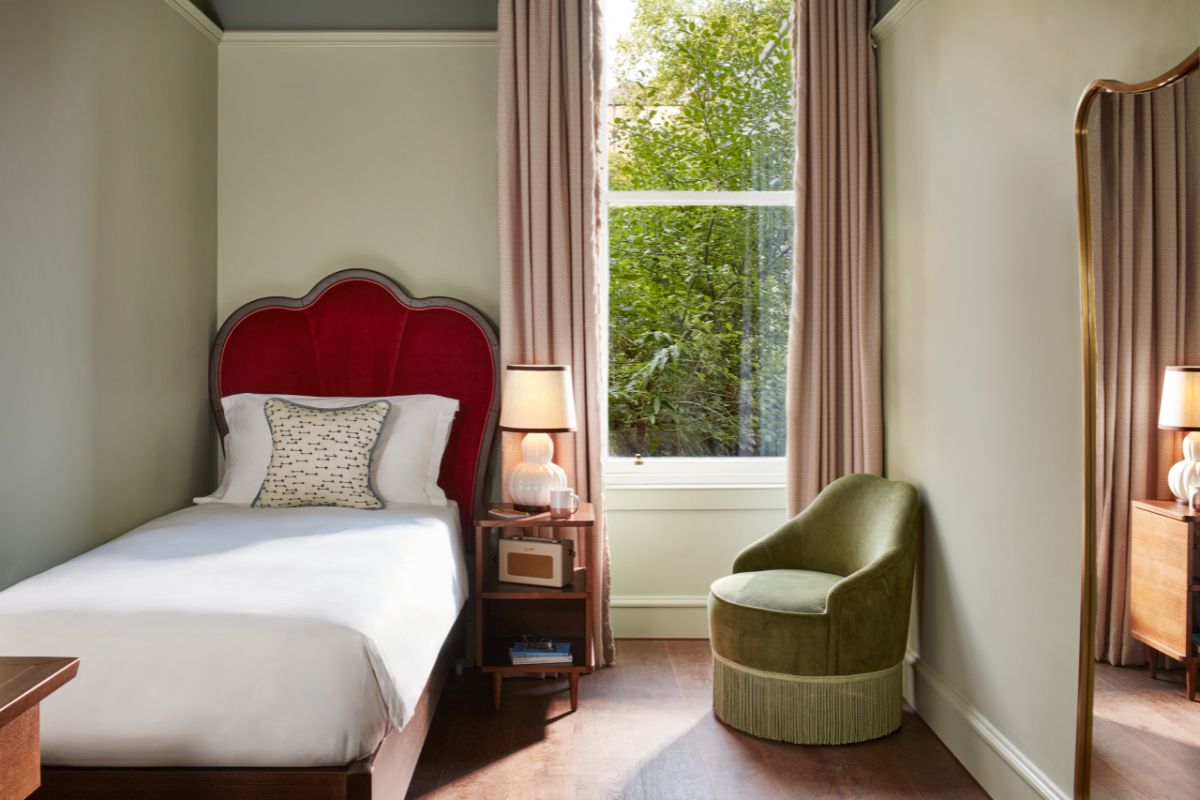a bedroom with a bed and a chair