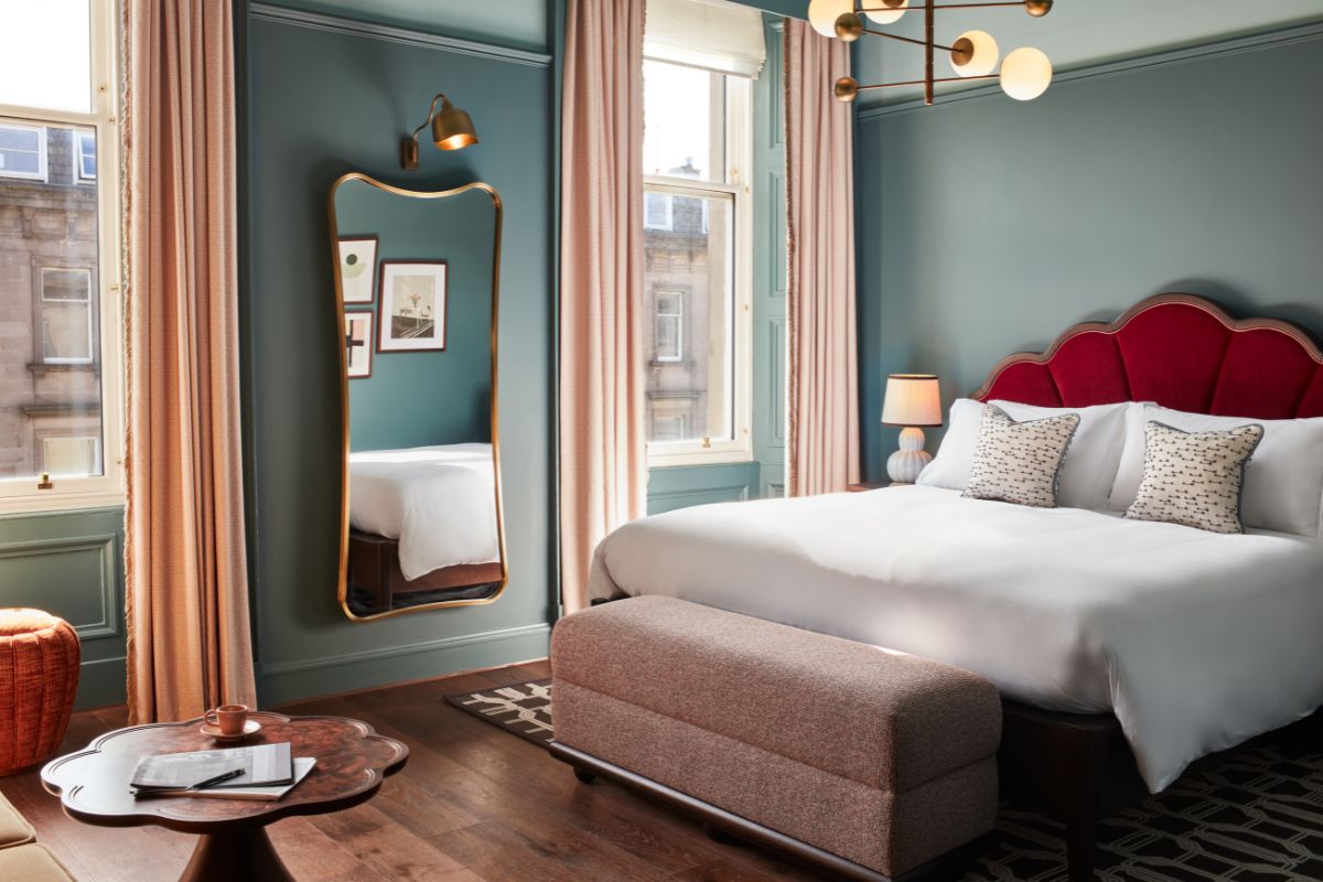 a bedroom with a bed and a mirror