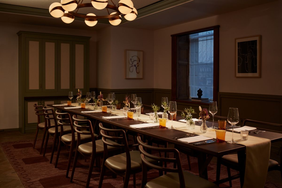 a long table with glasses and plates on it