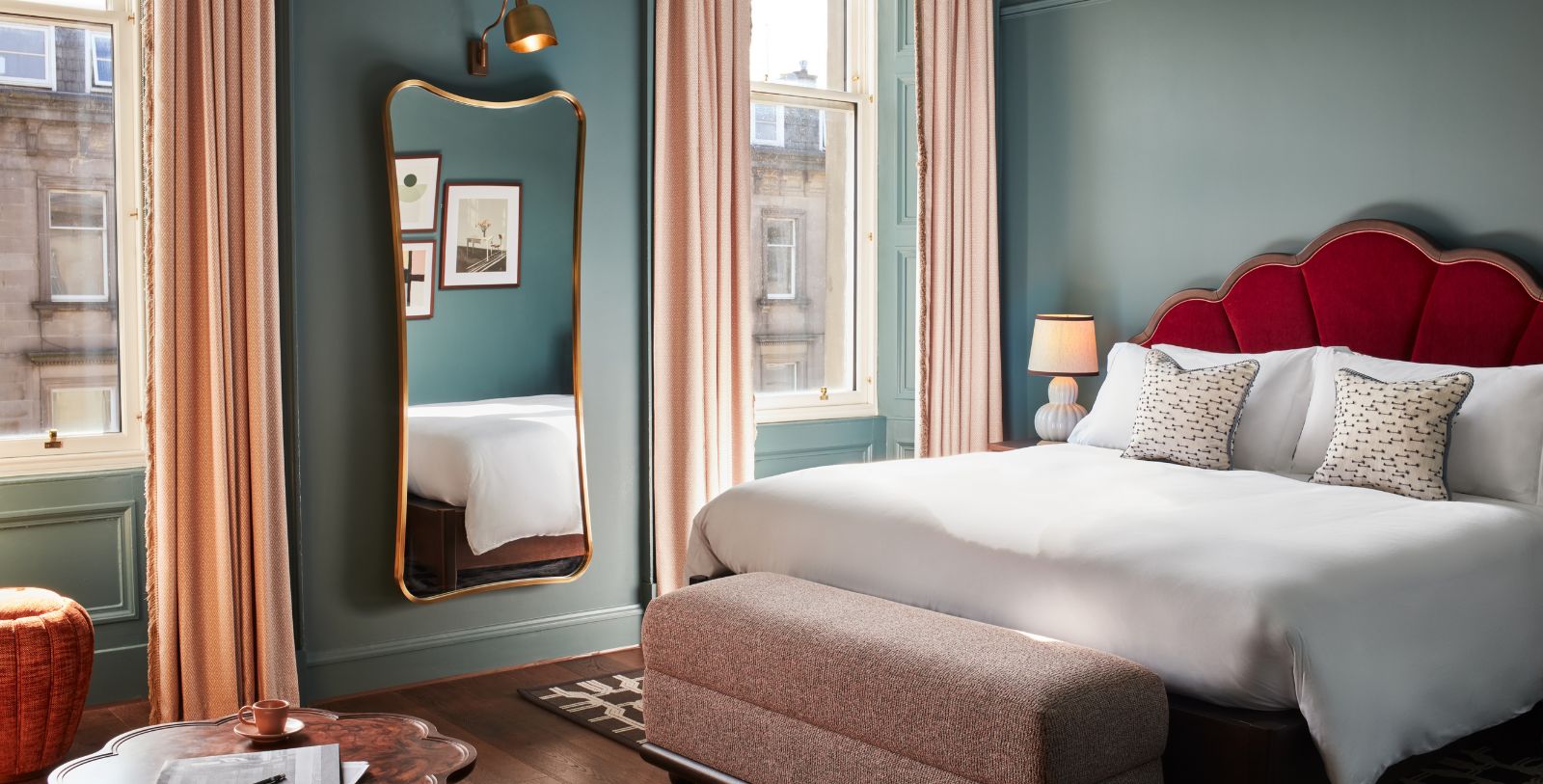 a bedroom with a mirror and a bed