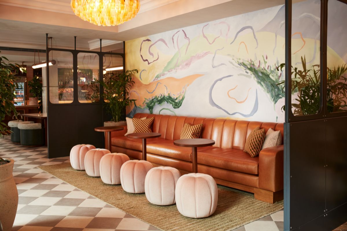 a room with a couch and chairs