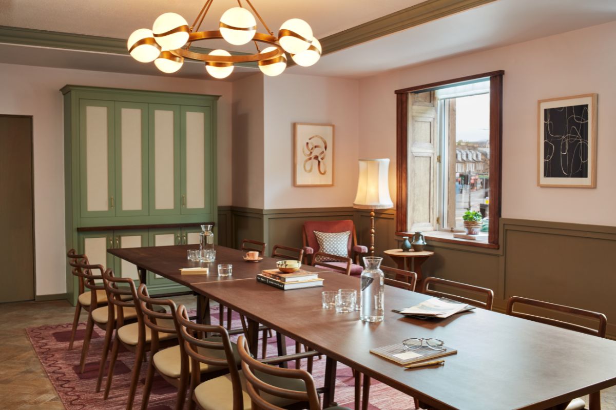 a room with a long table and chairs
