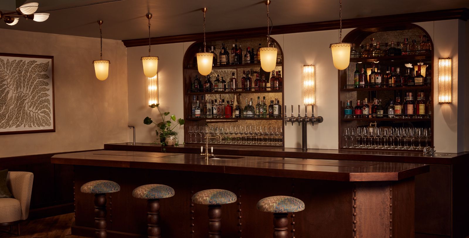 a bar with a row of bottles and glasses