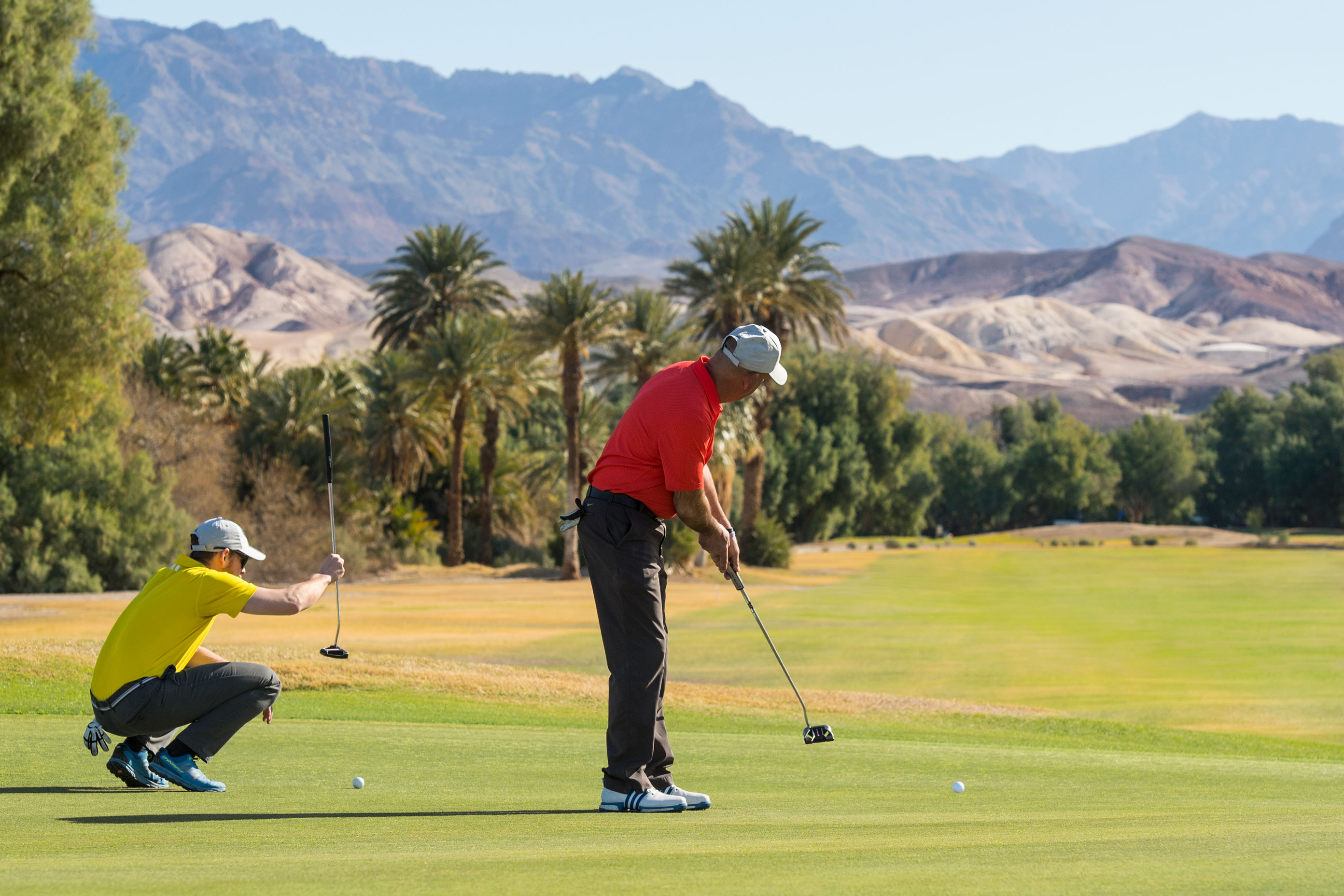 a man and woman playing golf