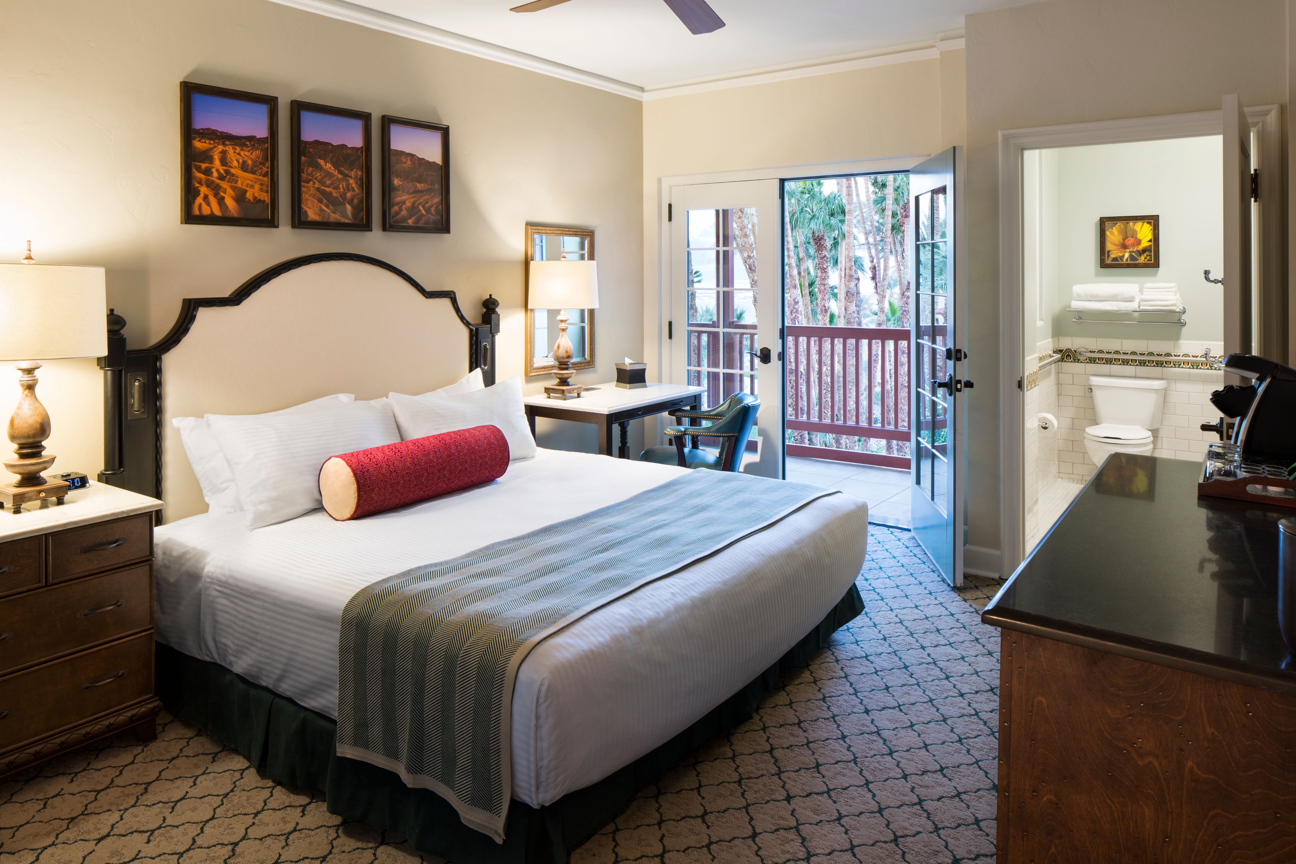 a bedroom with a bed and a desk and a television