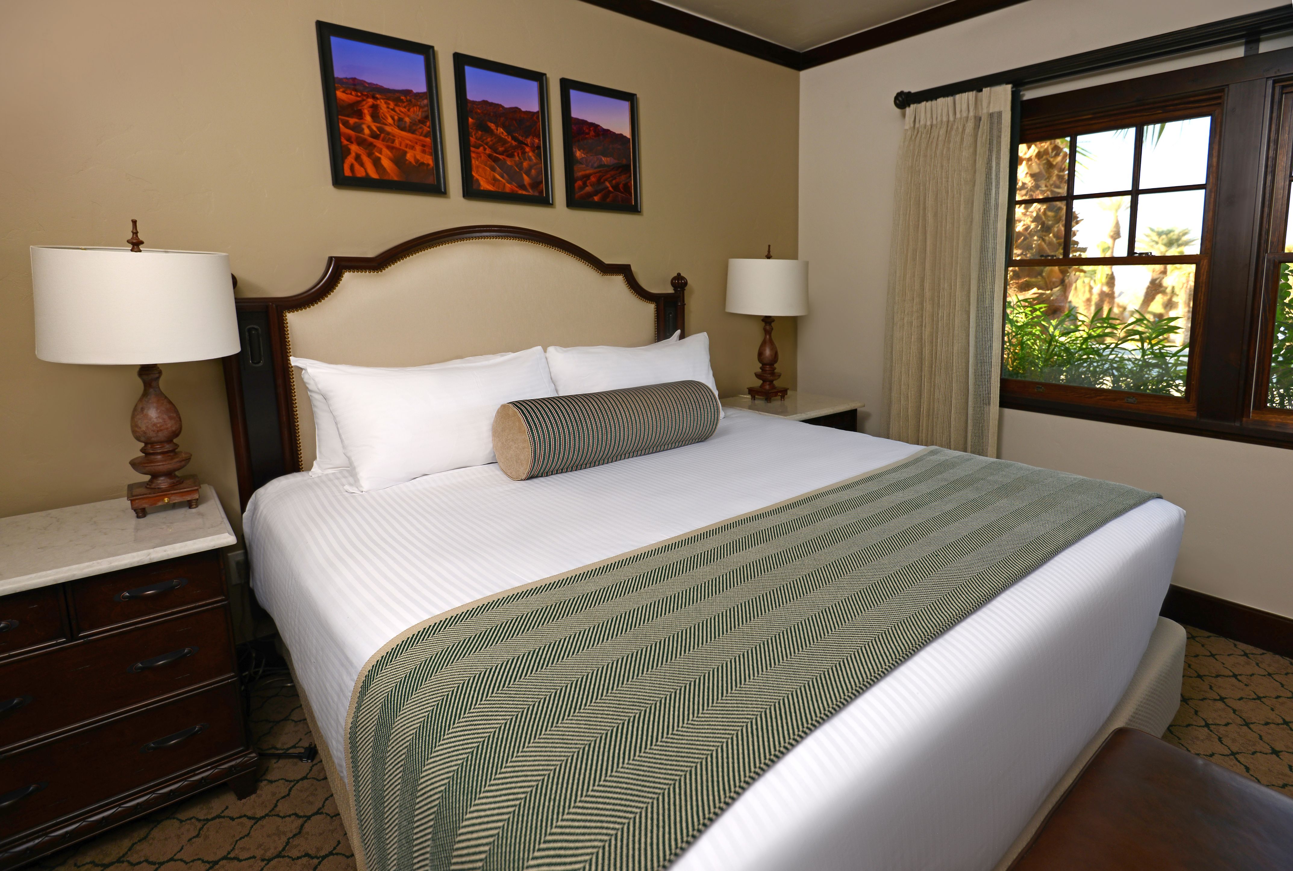a bed with a pillow and a lamp