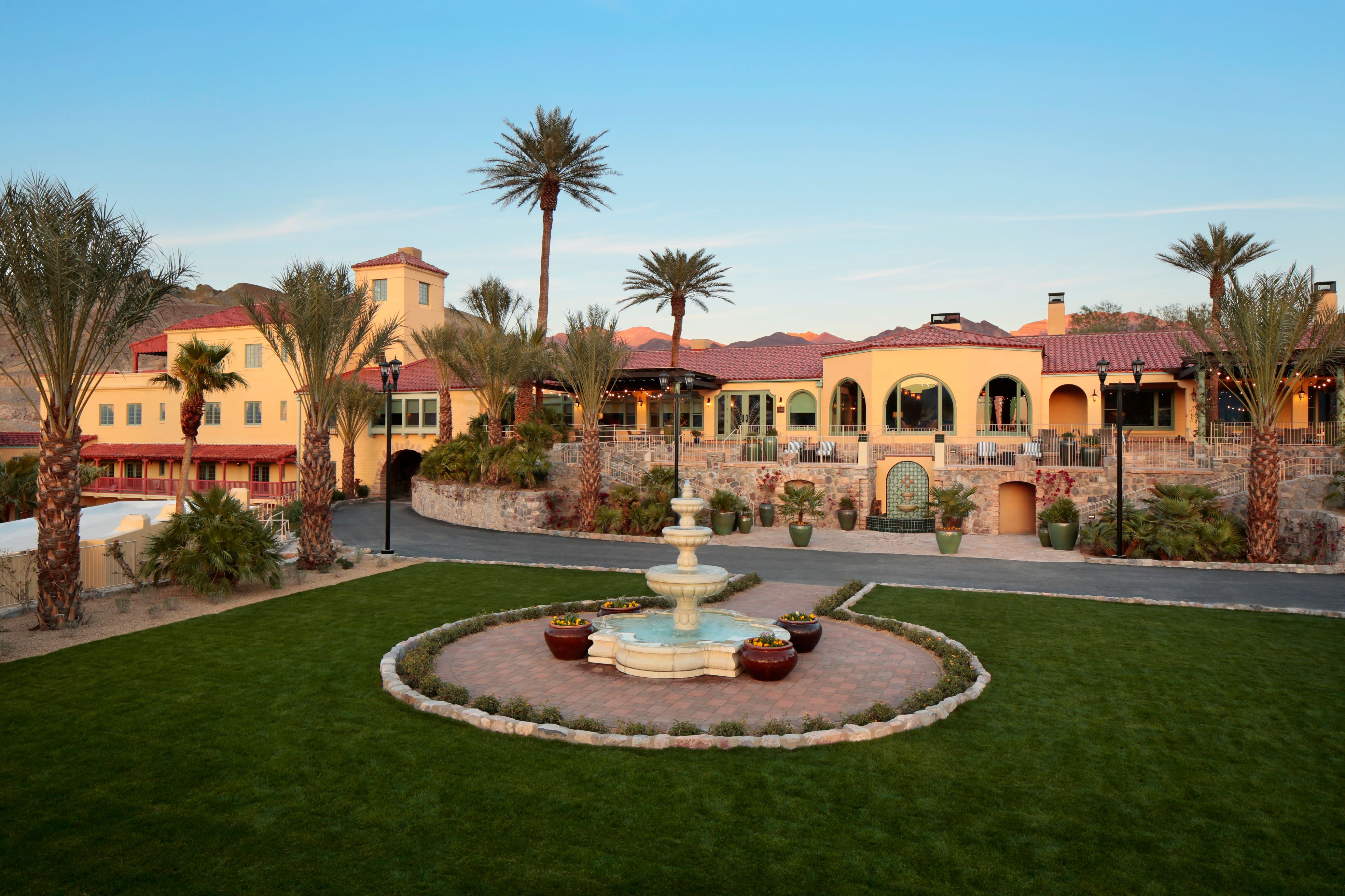 a fountain in a courtyard with a building in the background