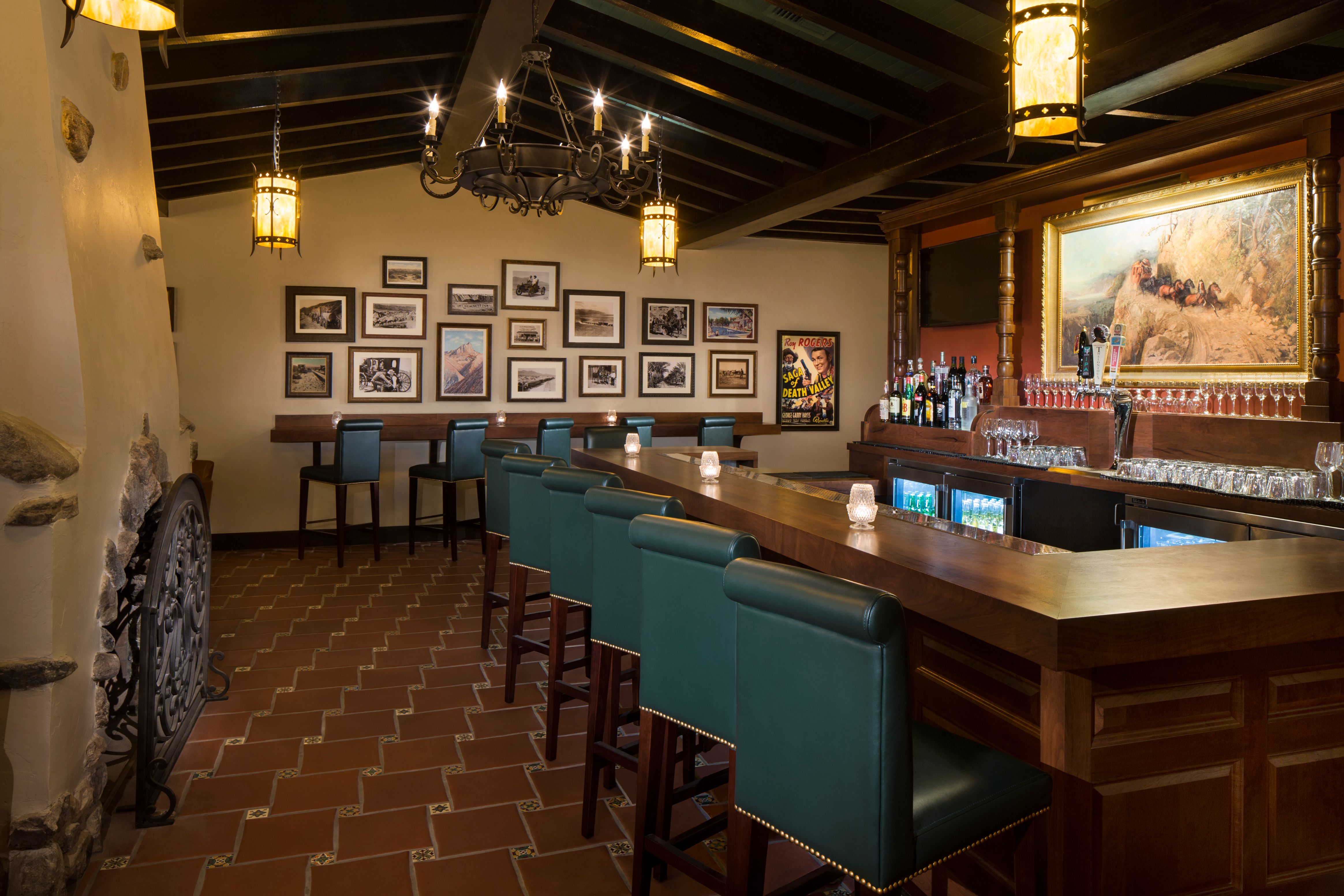 a bar with chairs and a chandelier
