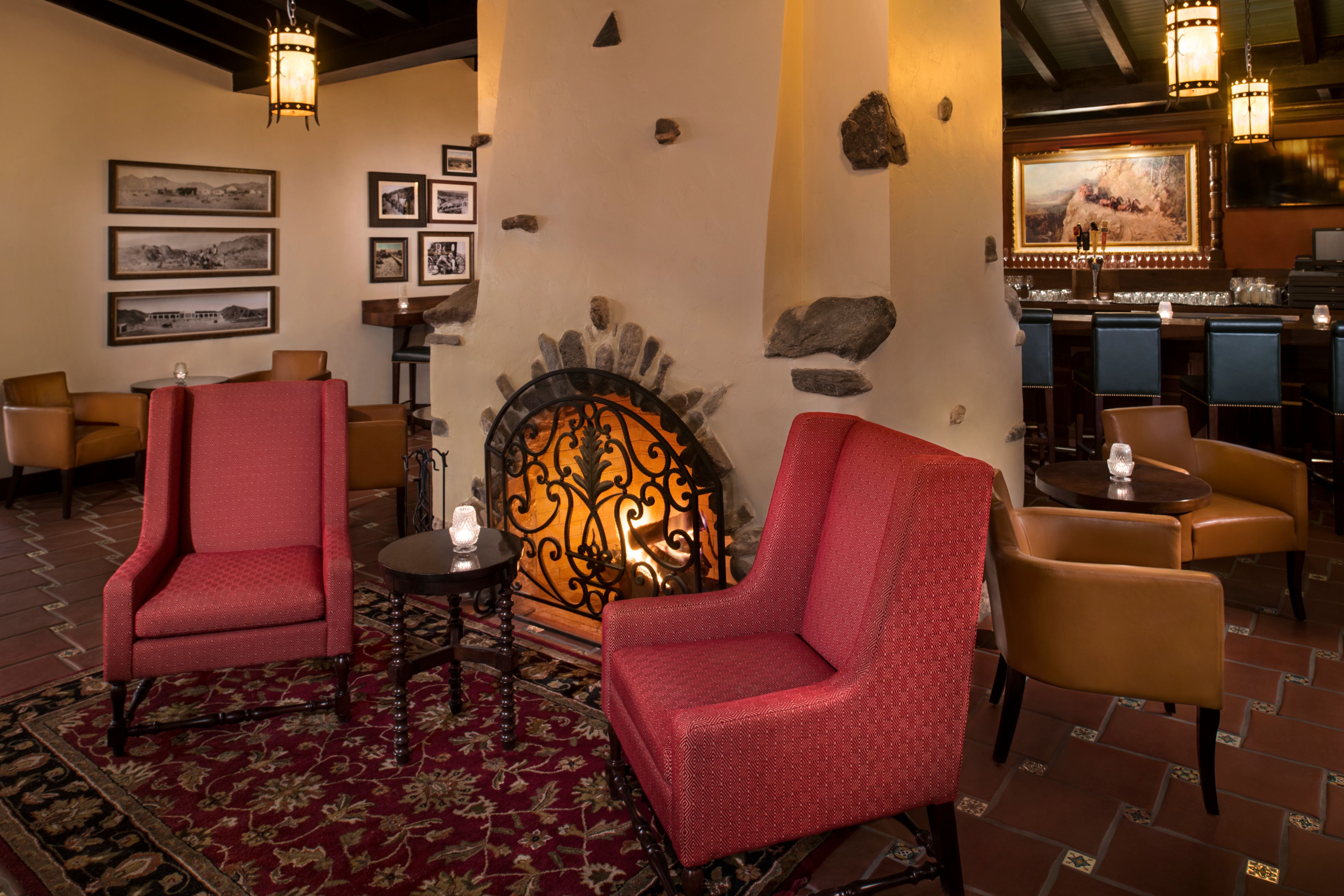 a room with red chairs and a fireplace