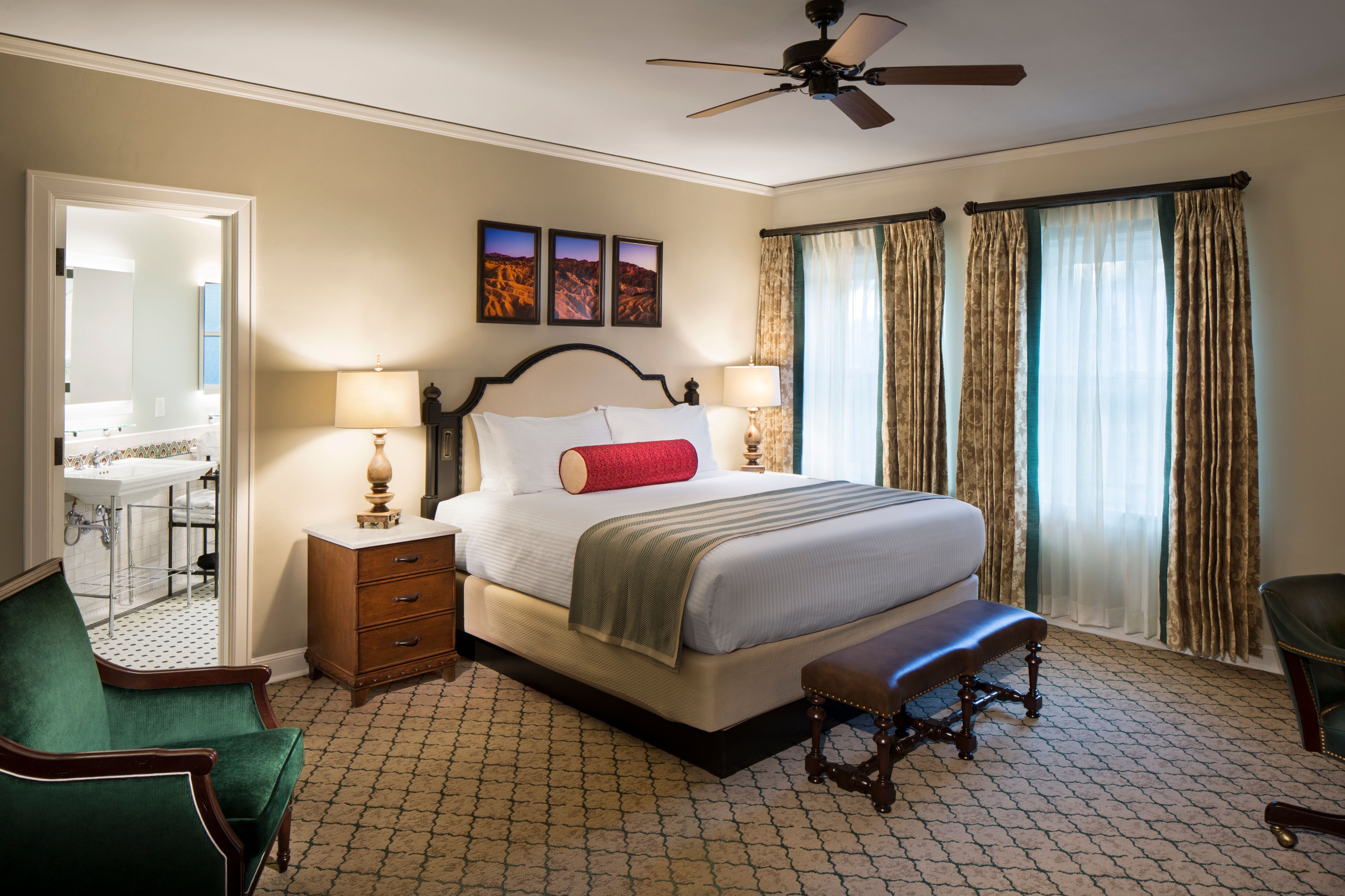 a bedroom with a bed and a fan