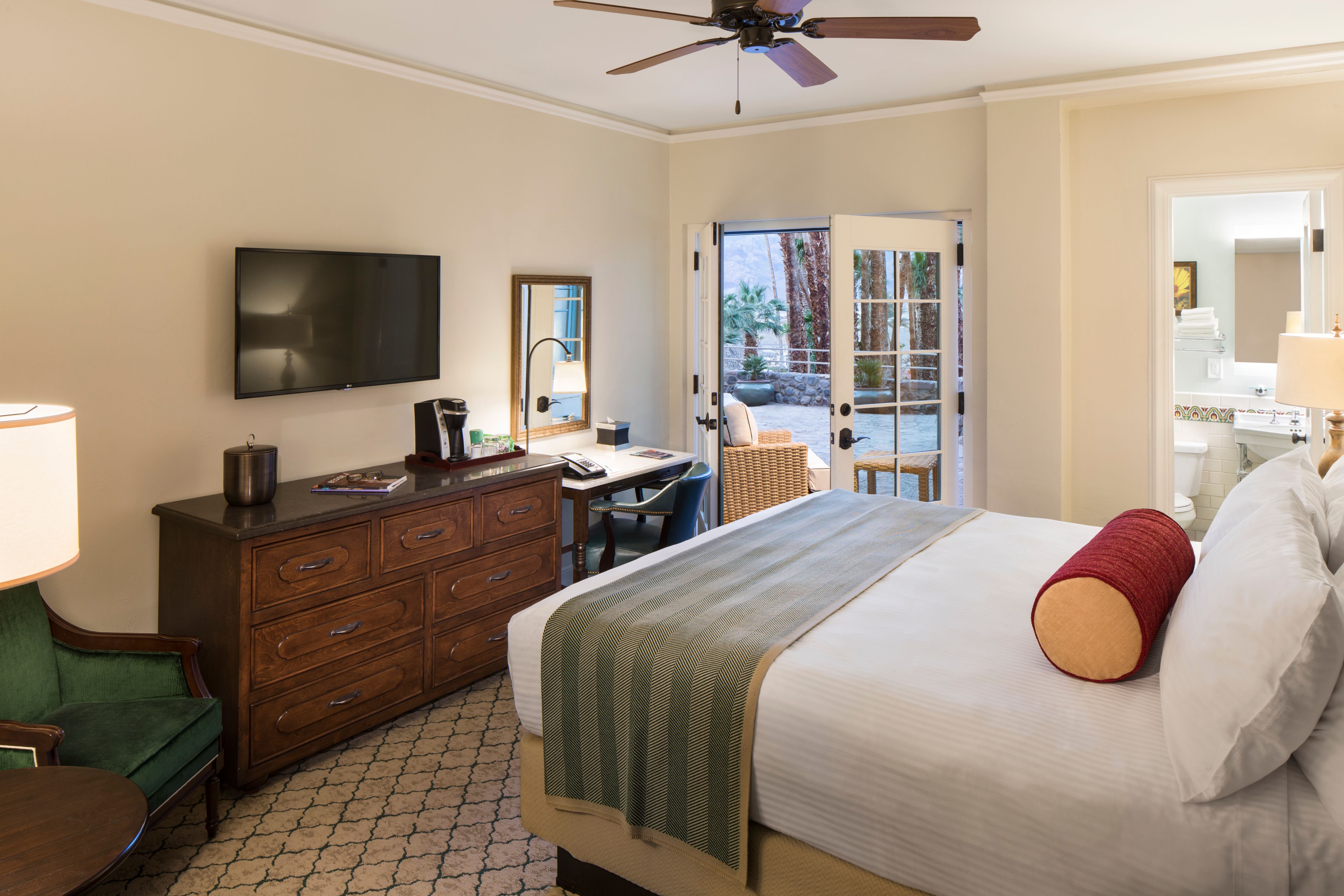 a room with a bed and a television
