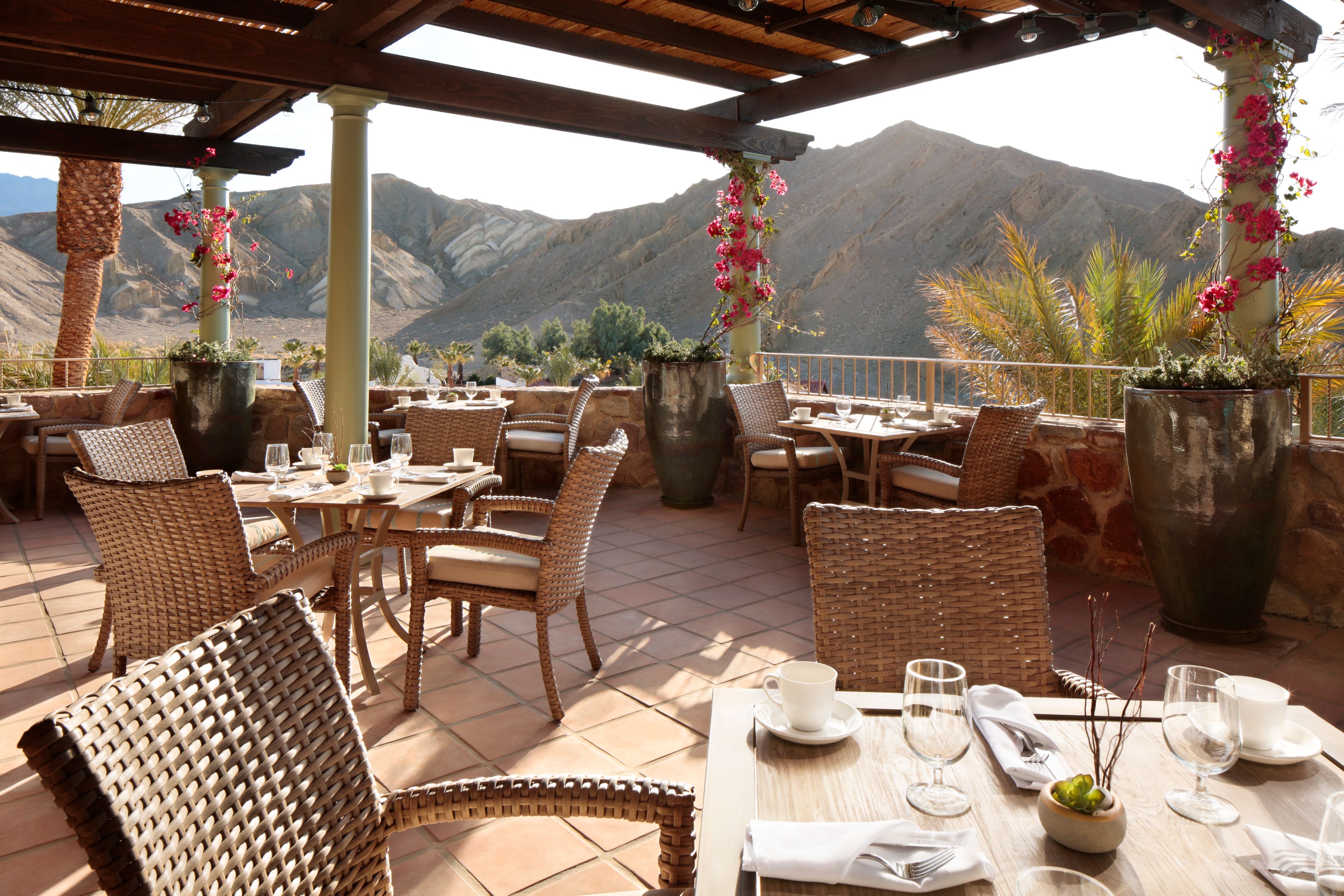a restaurant with a view of mountains and trees