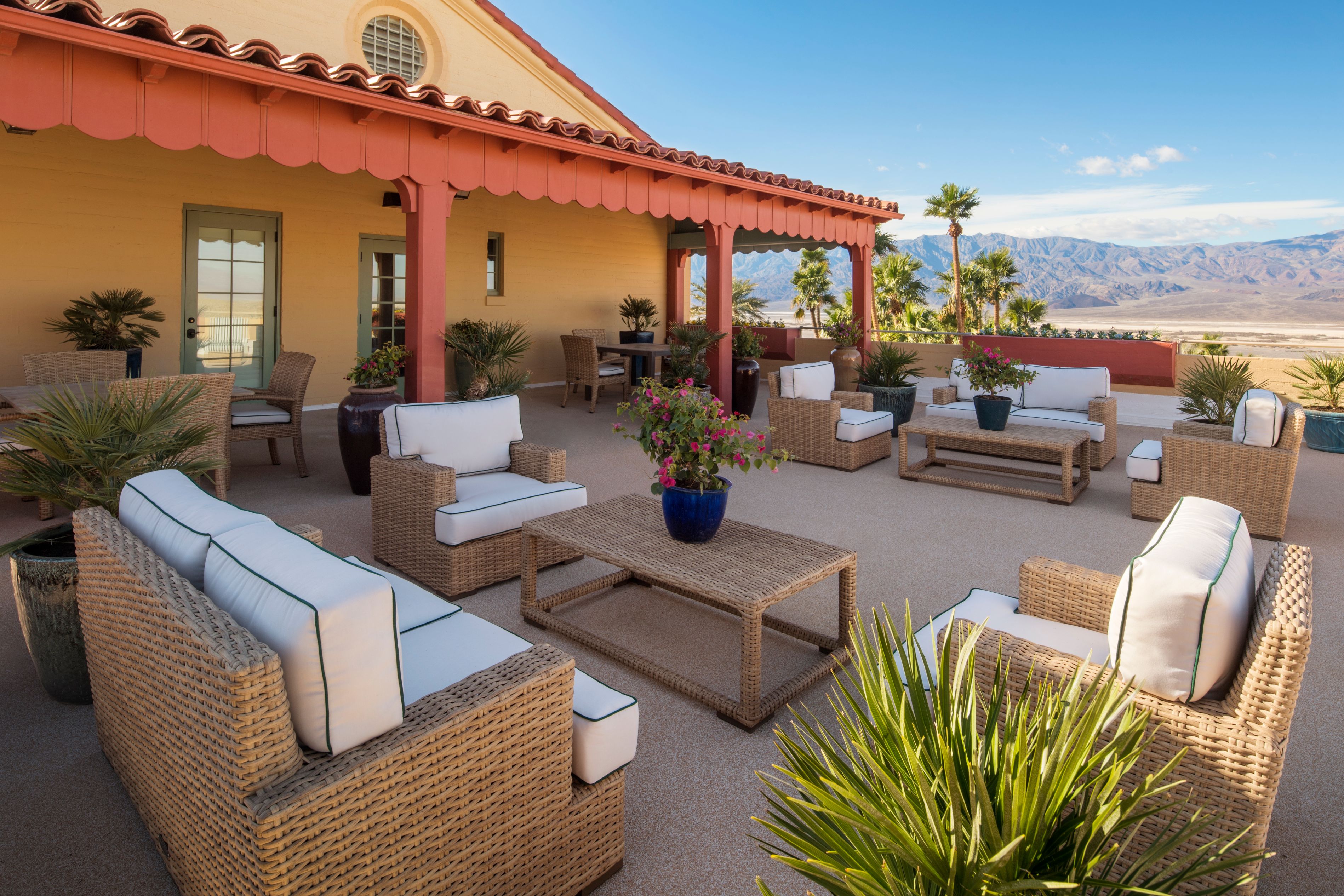 a patio with furniture and plants on the patio