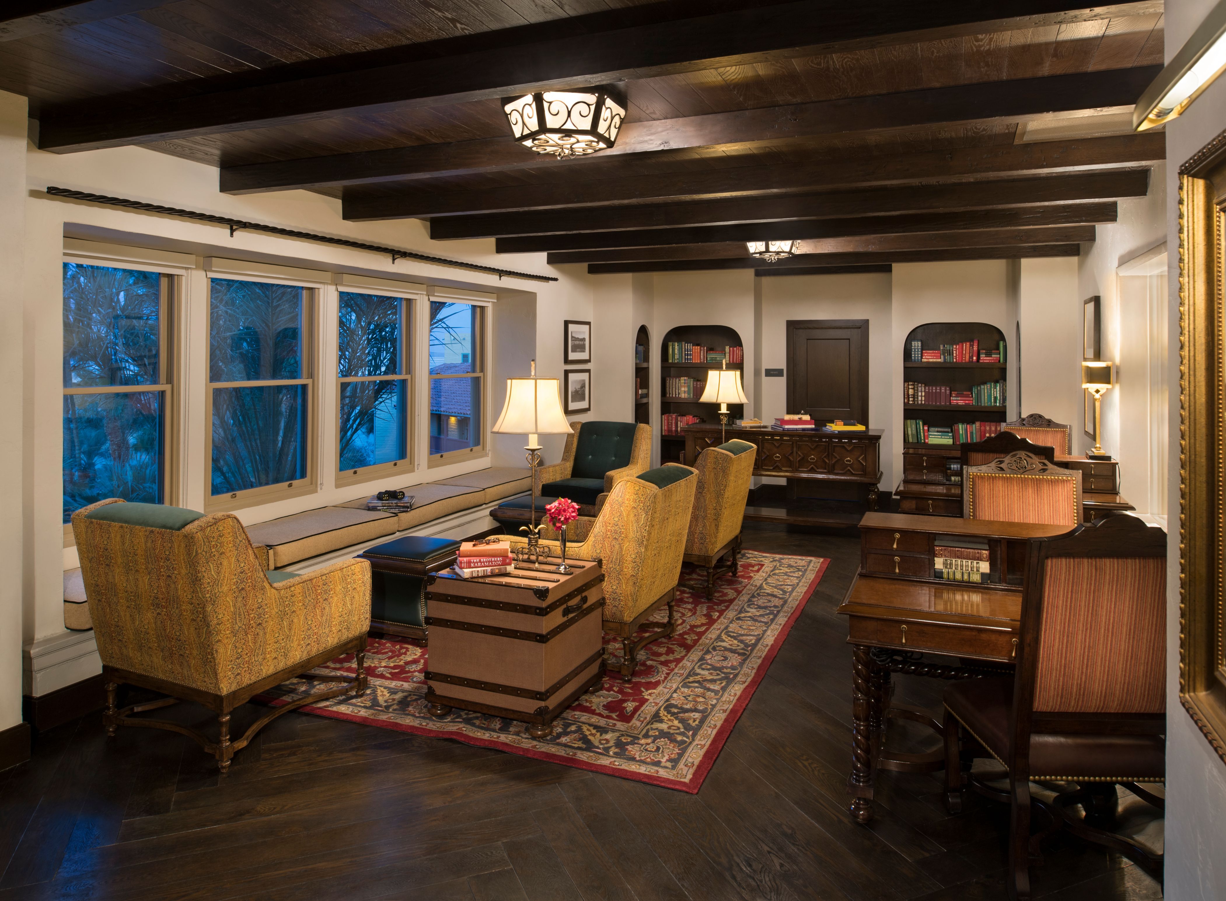 a room with a large window and a couch and chairs