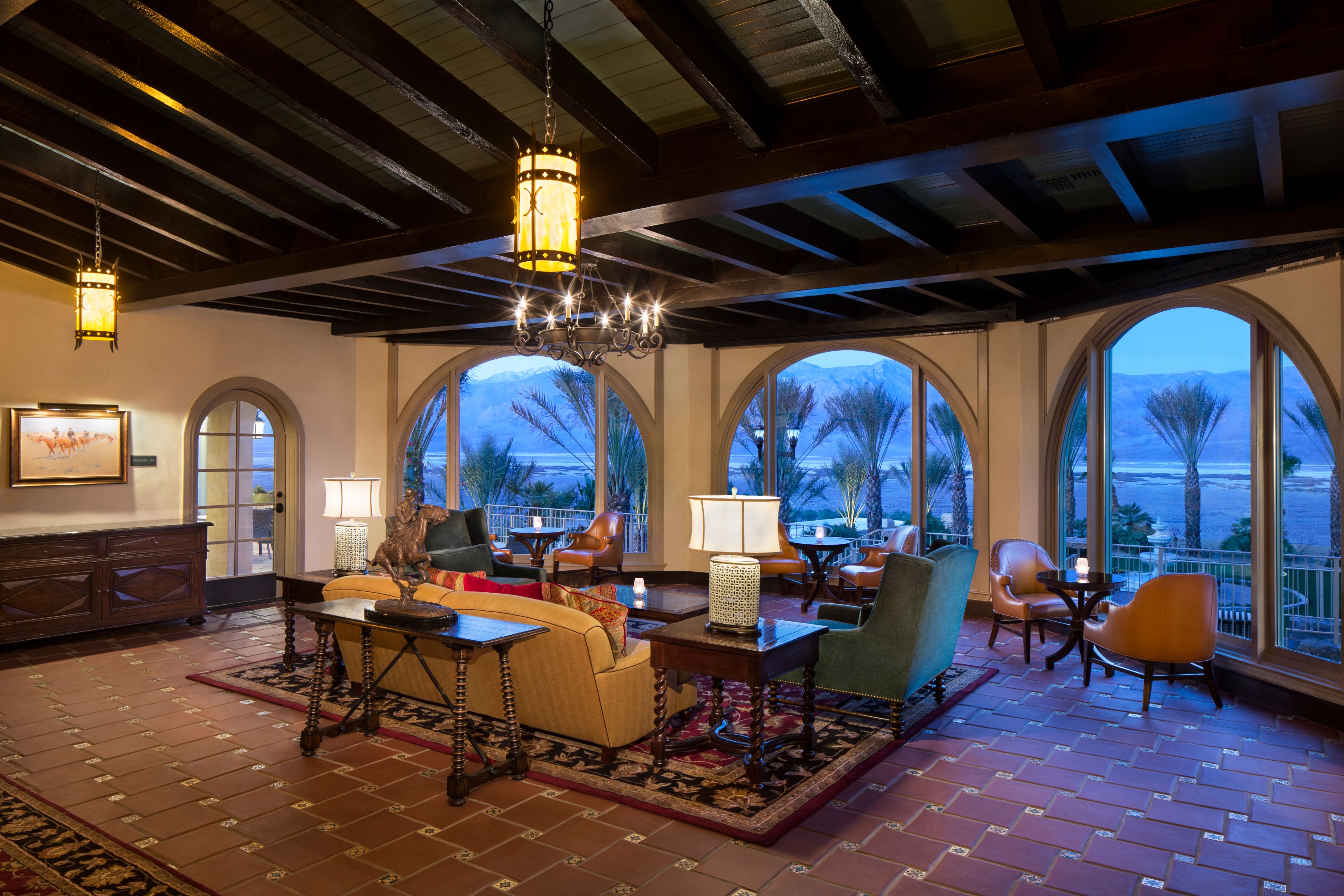 a room with a large window and a large table and chairs