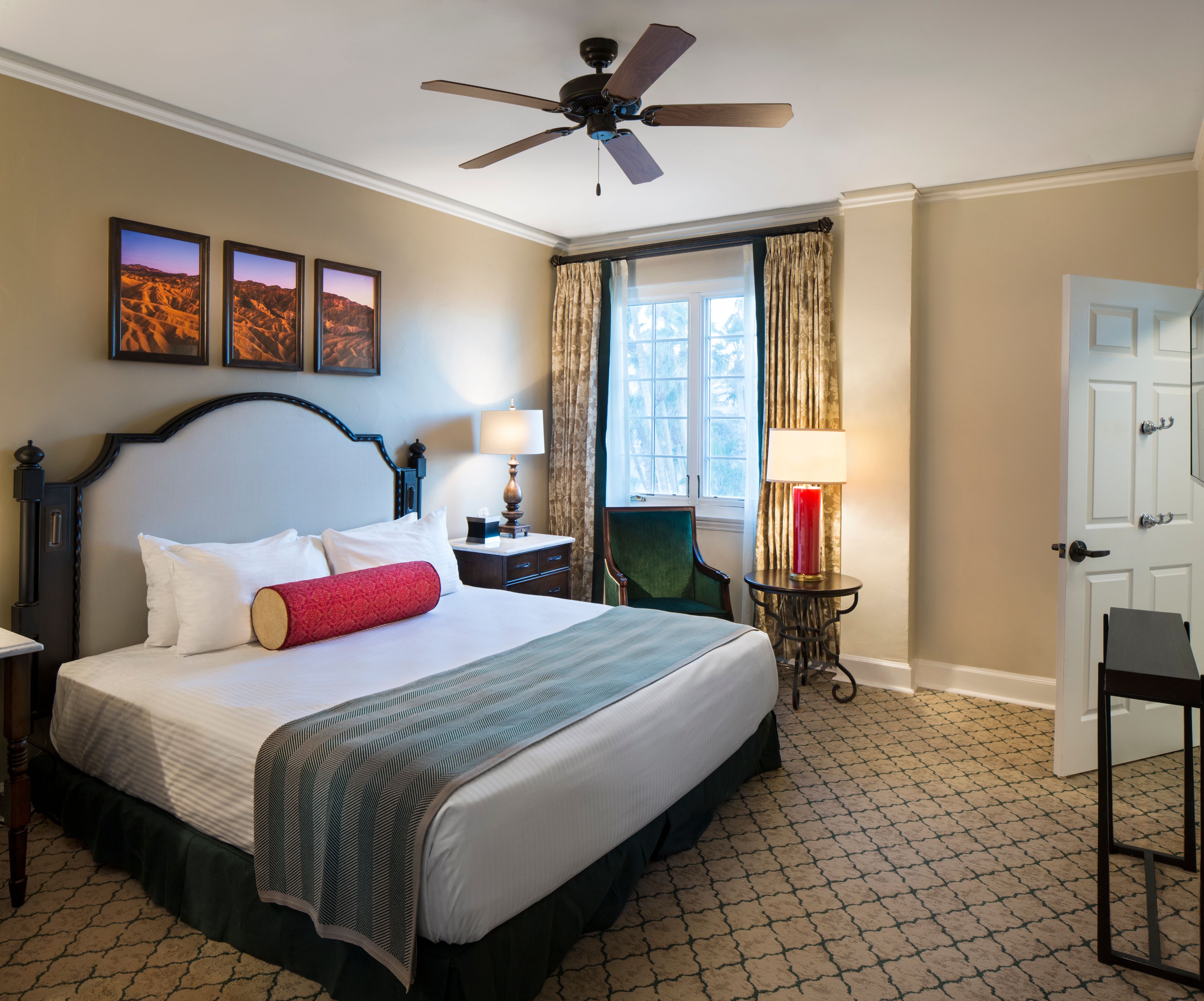 a bedroom with a bed and a fan