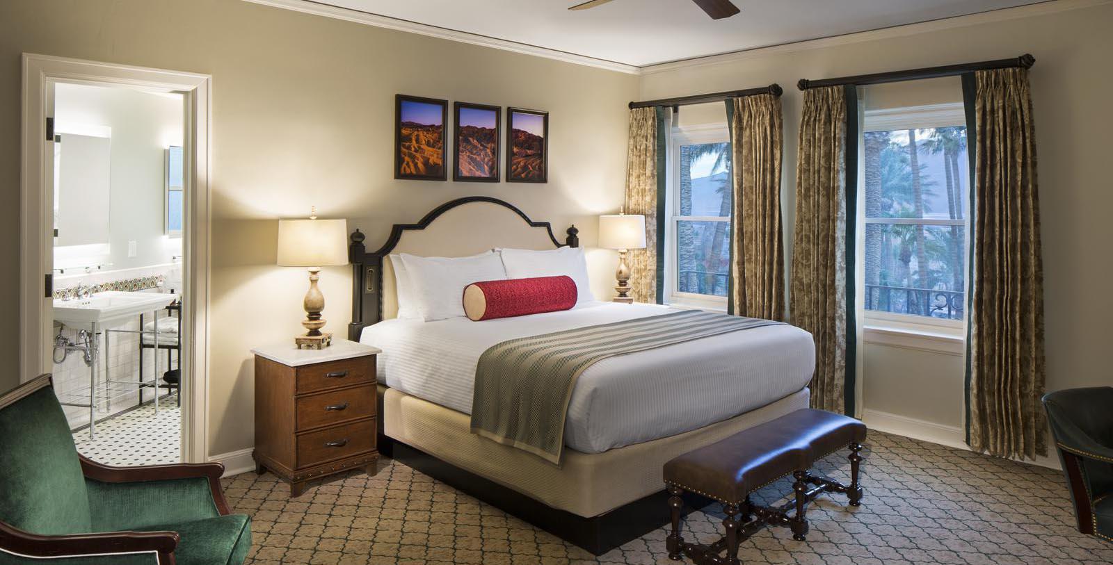 a bedroom with a bed and a fan