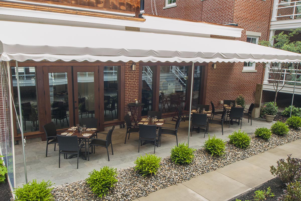a patio with tables and chairs