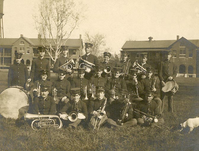 a group of people in uniform holding musical instruments
