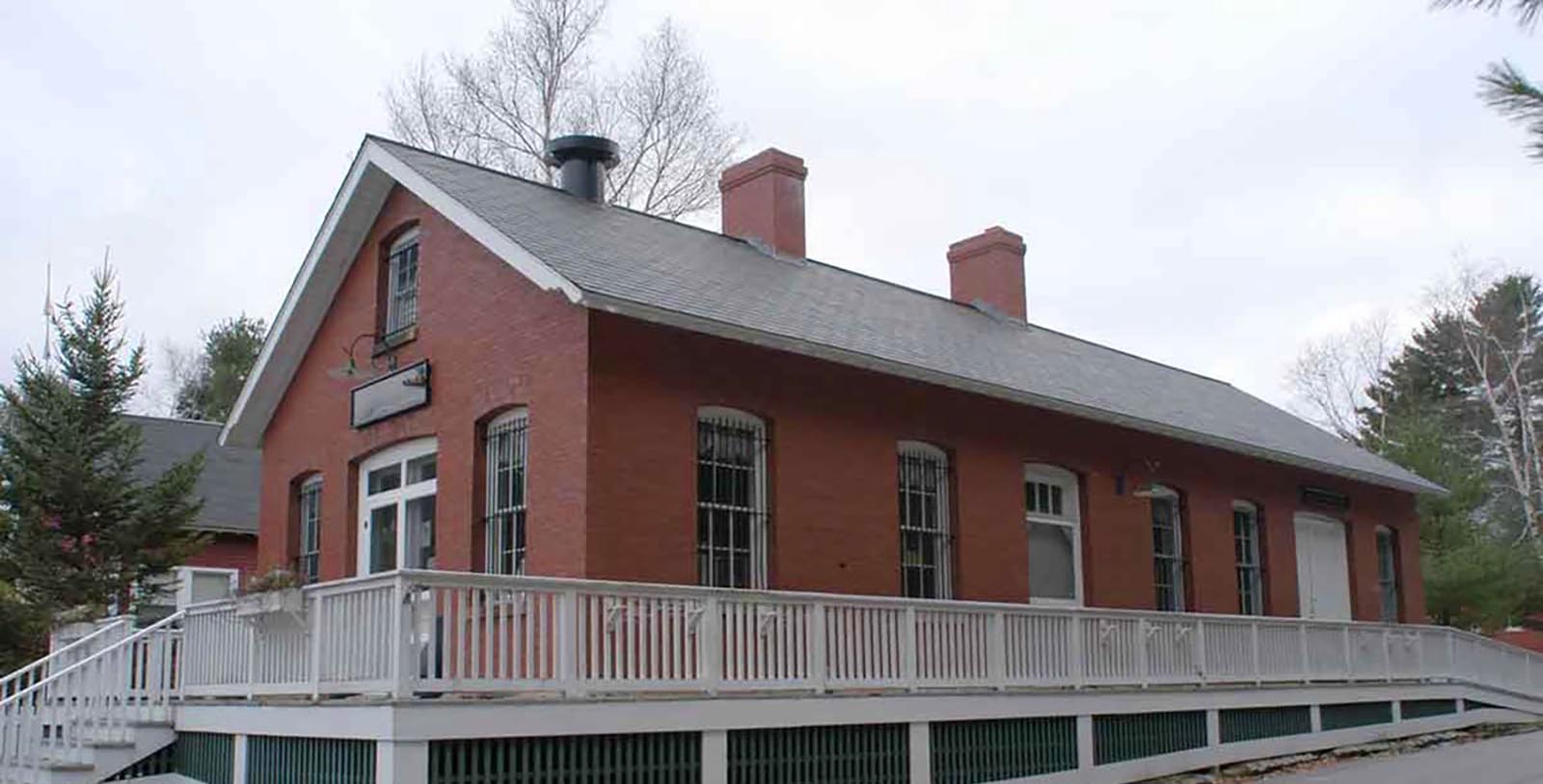 a brick building with a white railing