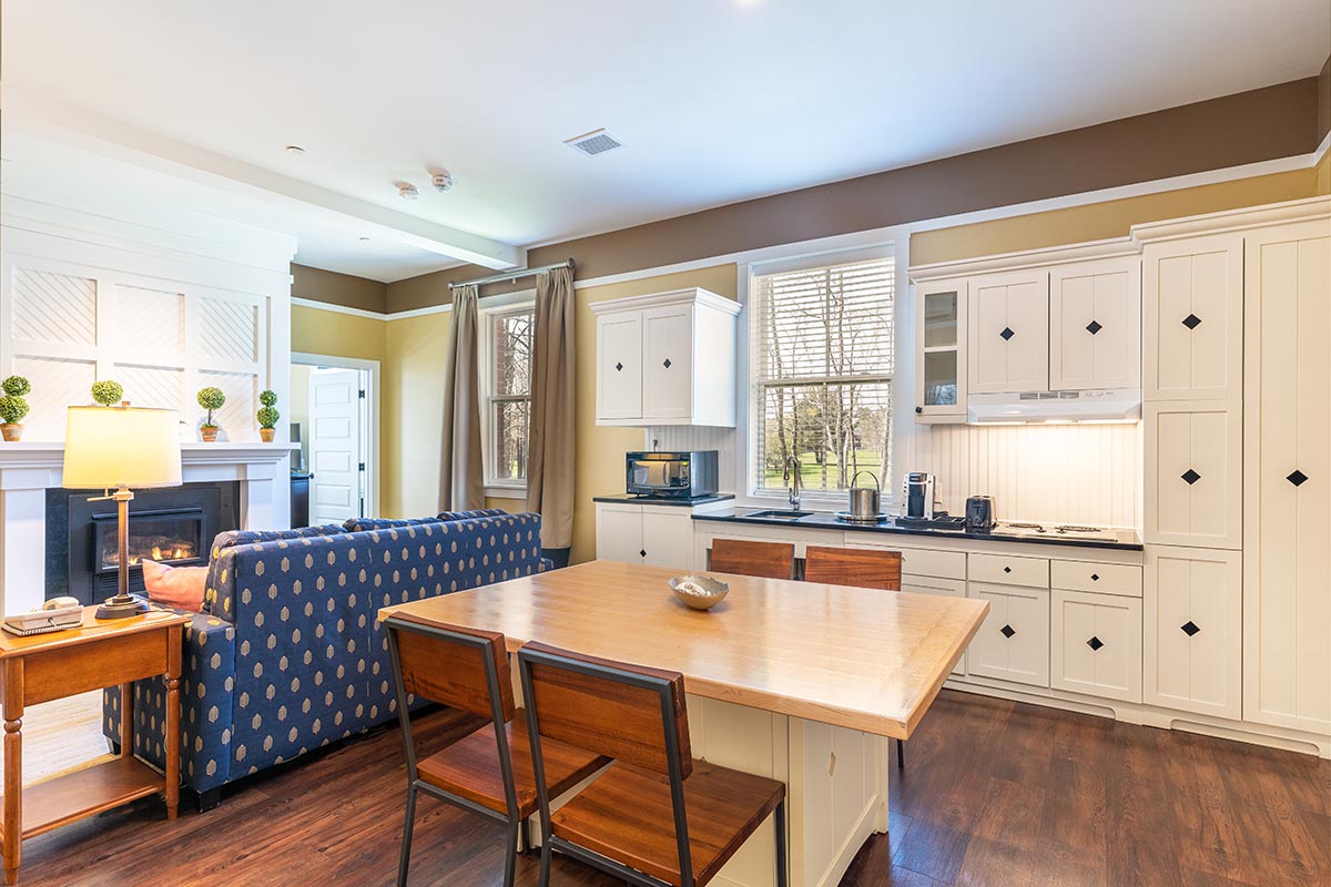 a kitchen and living room with a couch and a table