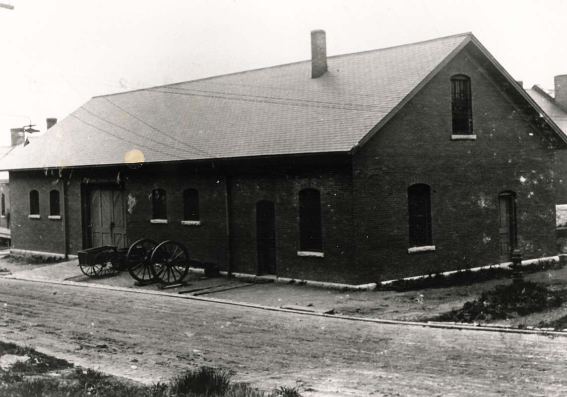 a brick building with a wagon on the side