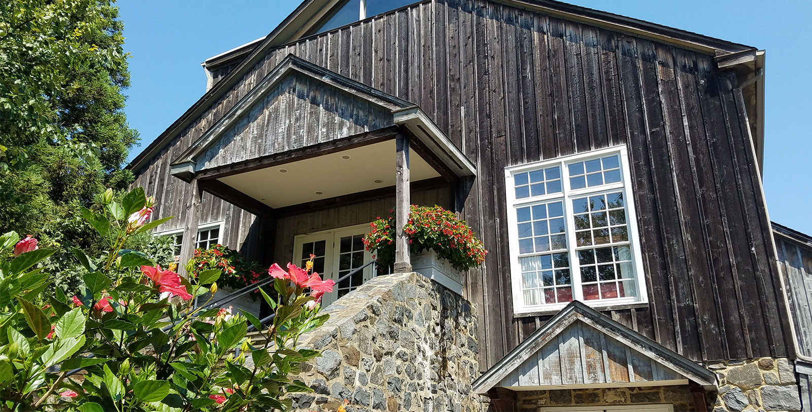 a house with a stone wall and a stone staircase