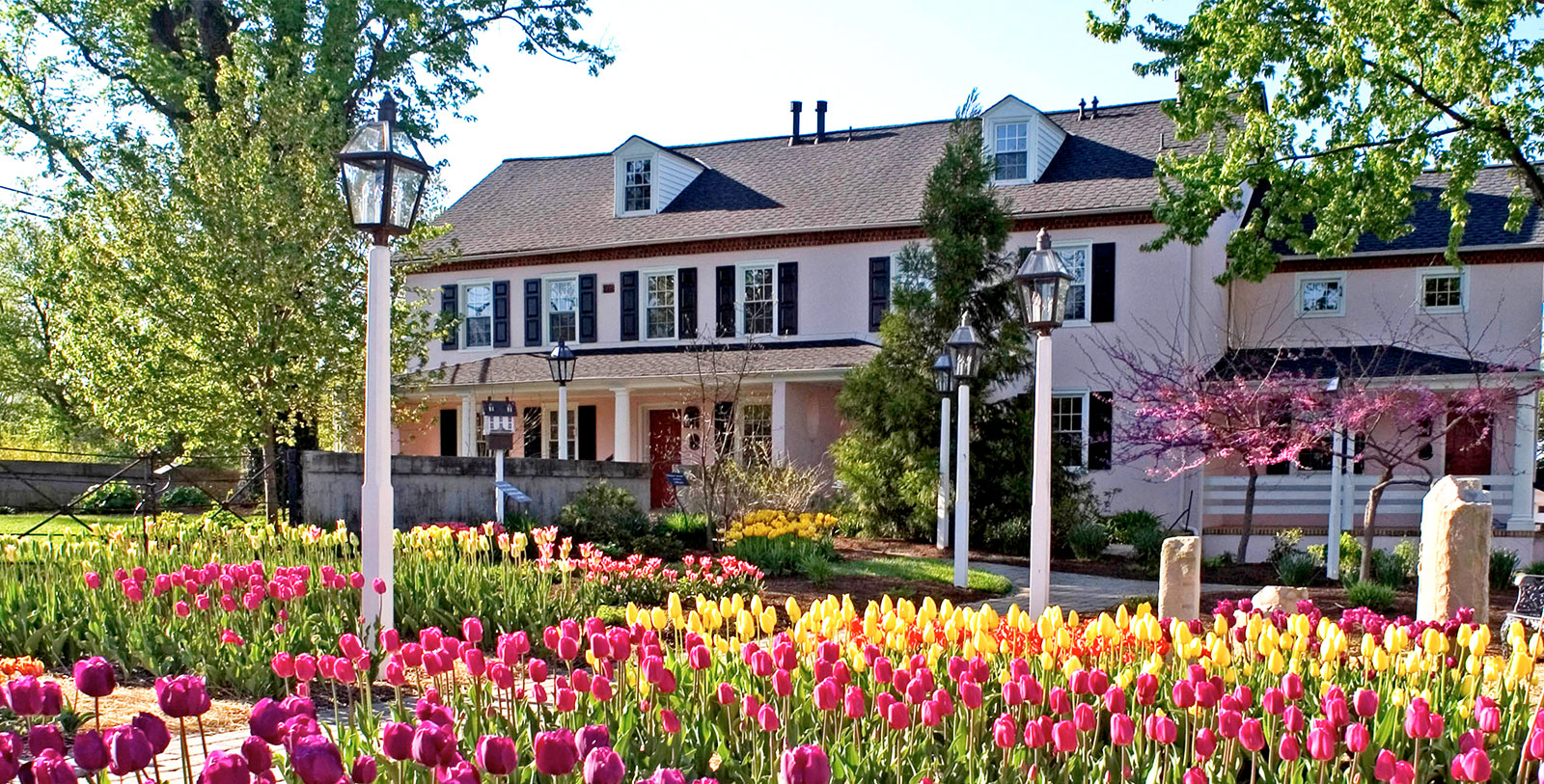 1600x813 exterior with tulips the inn at montchanin village montchanin delaware