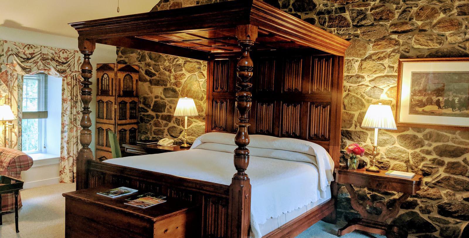 a bed with a wood four poster bed