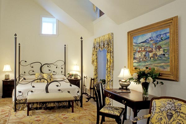 a bedroom with a bed and a desk