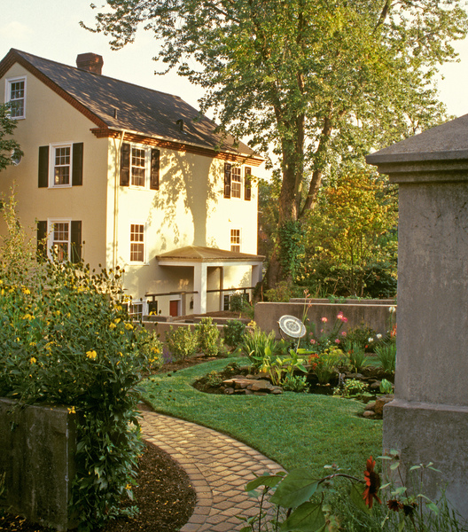 a house with a garden and a stone wall