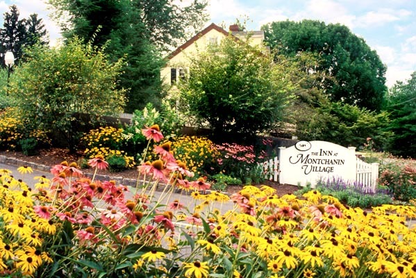 a sign in front of a village