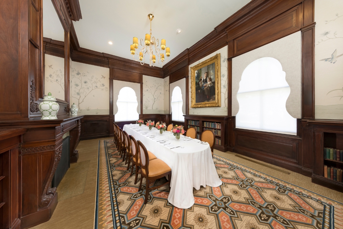 a room with a long table and chairs
