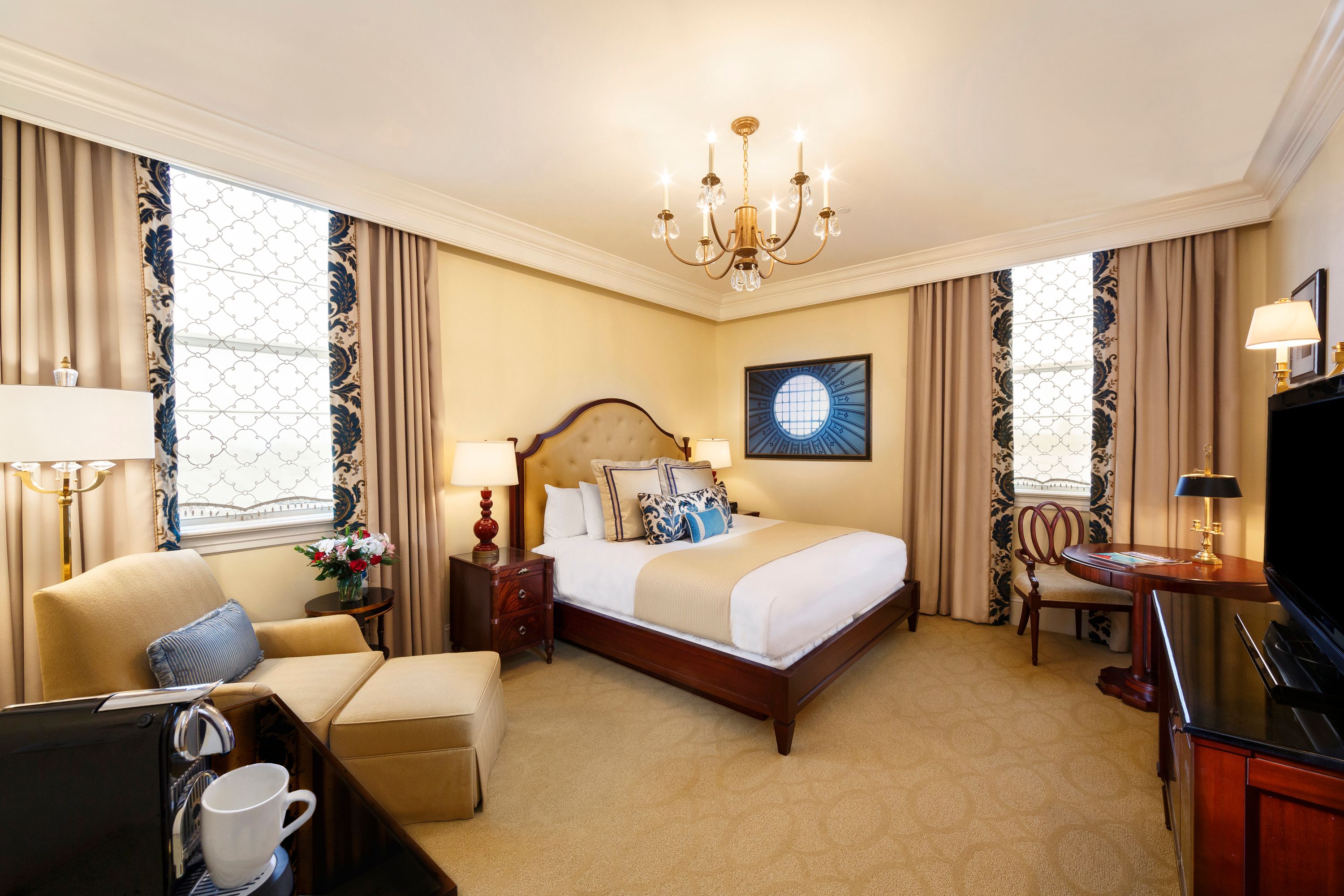 a bedroom with a bed and a chandelier