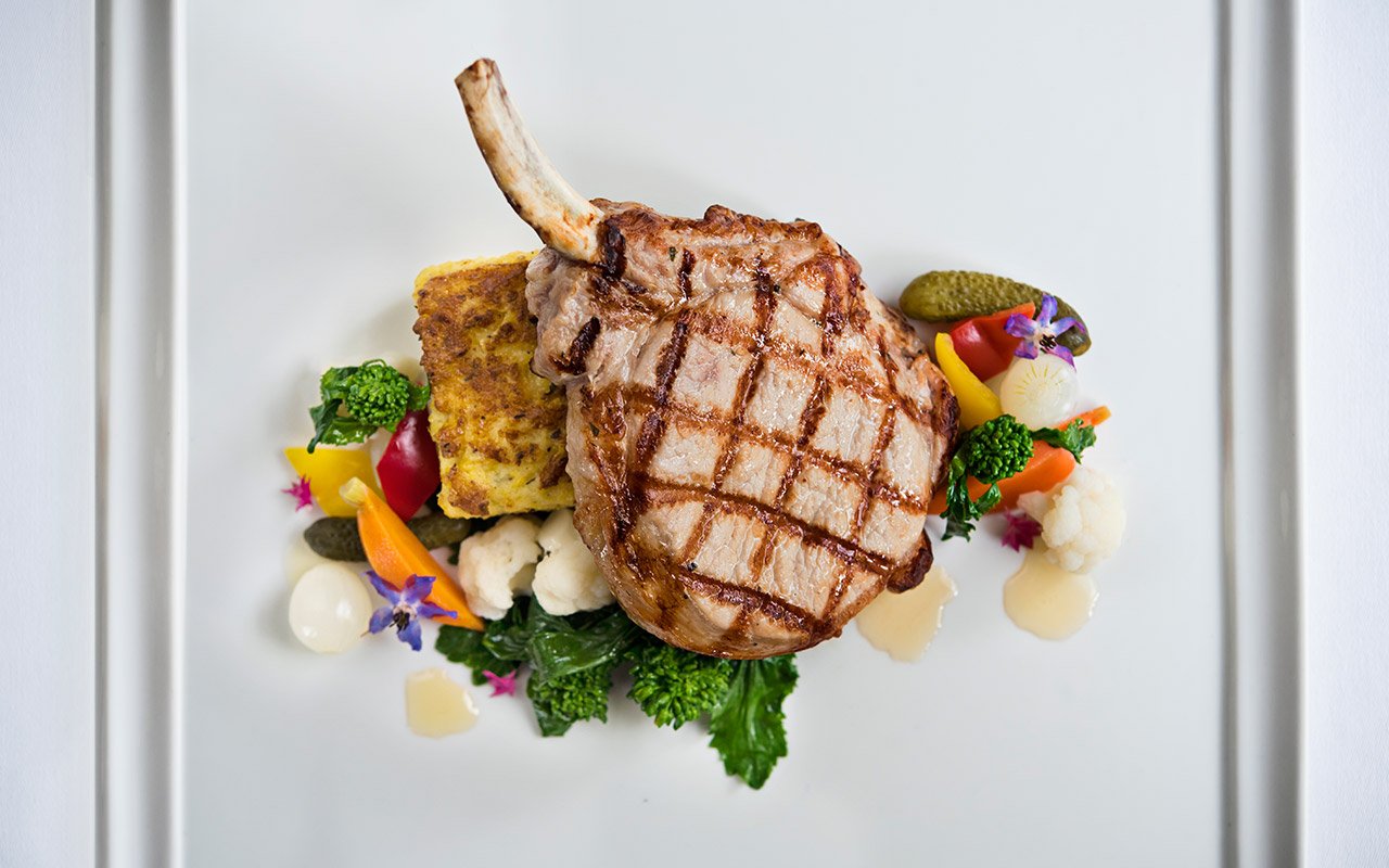 a plate of food with a piece of meat and vegetables