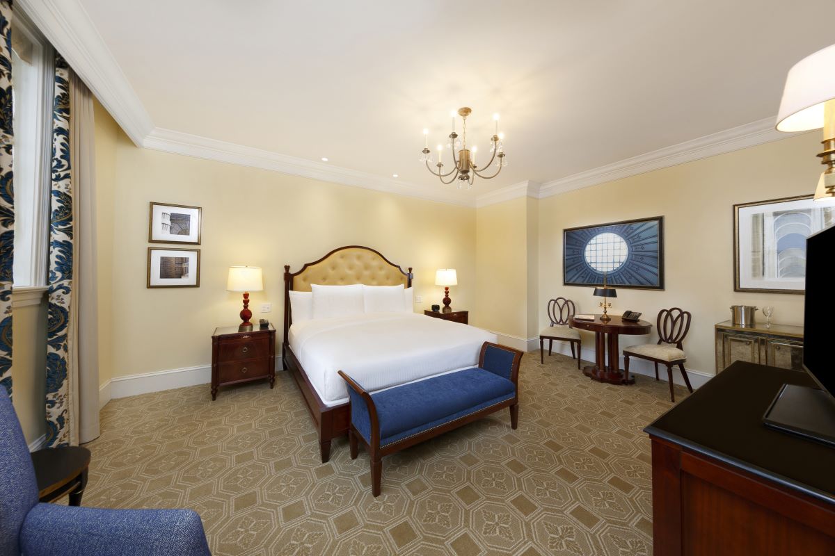 a bedroom with a bed and a couch