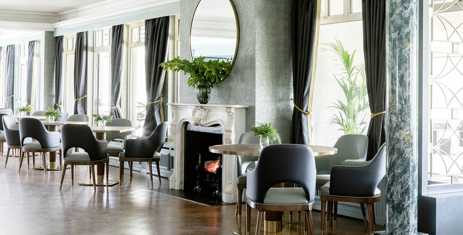 a room with a fireplace and tables