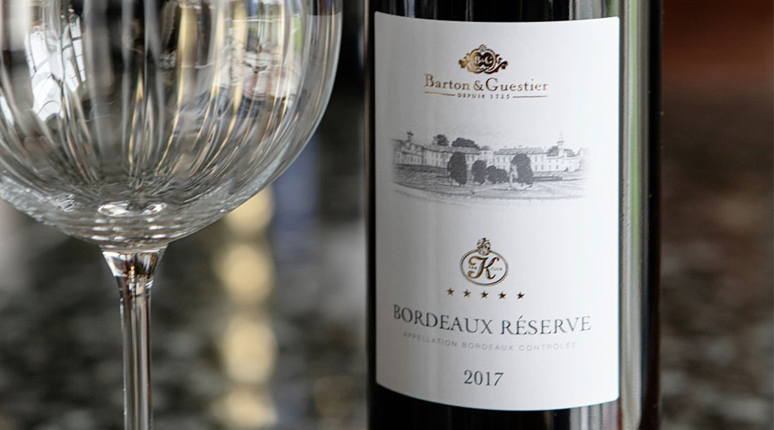 a bottle of wine next to a glass